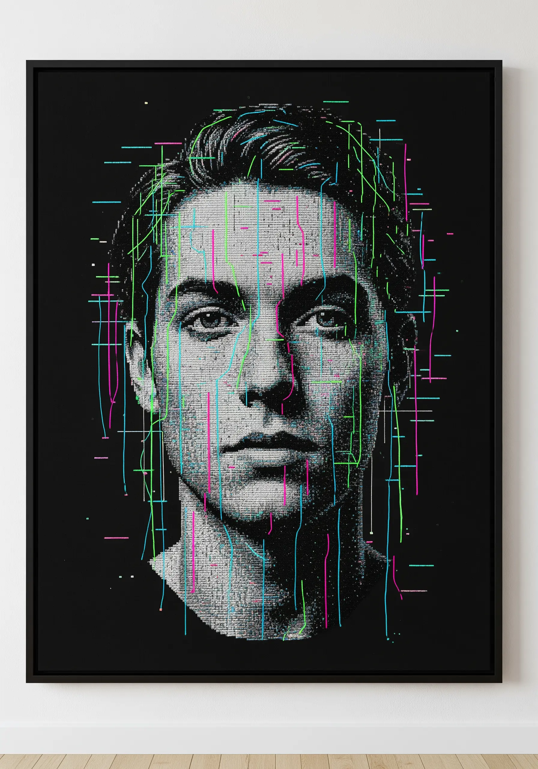 A framed, embroidered portrait of a man with neon green and pink threads creating a 'glitch' effect.