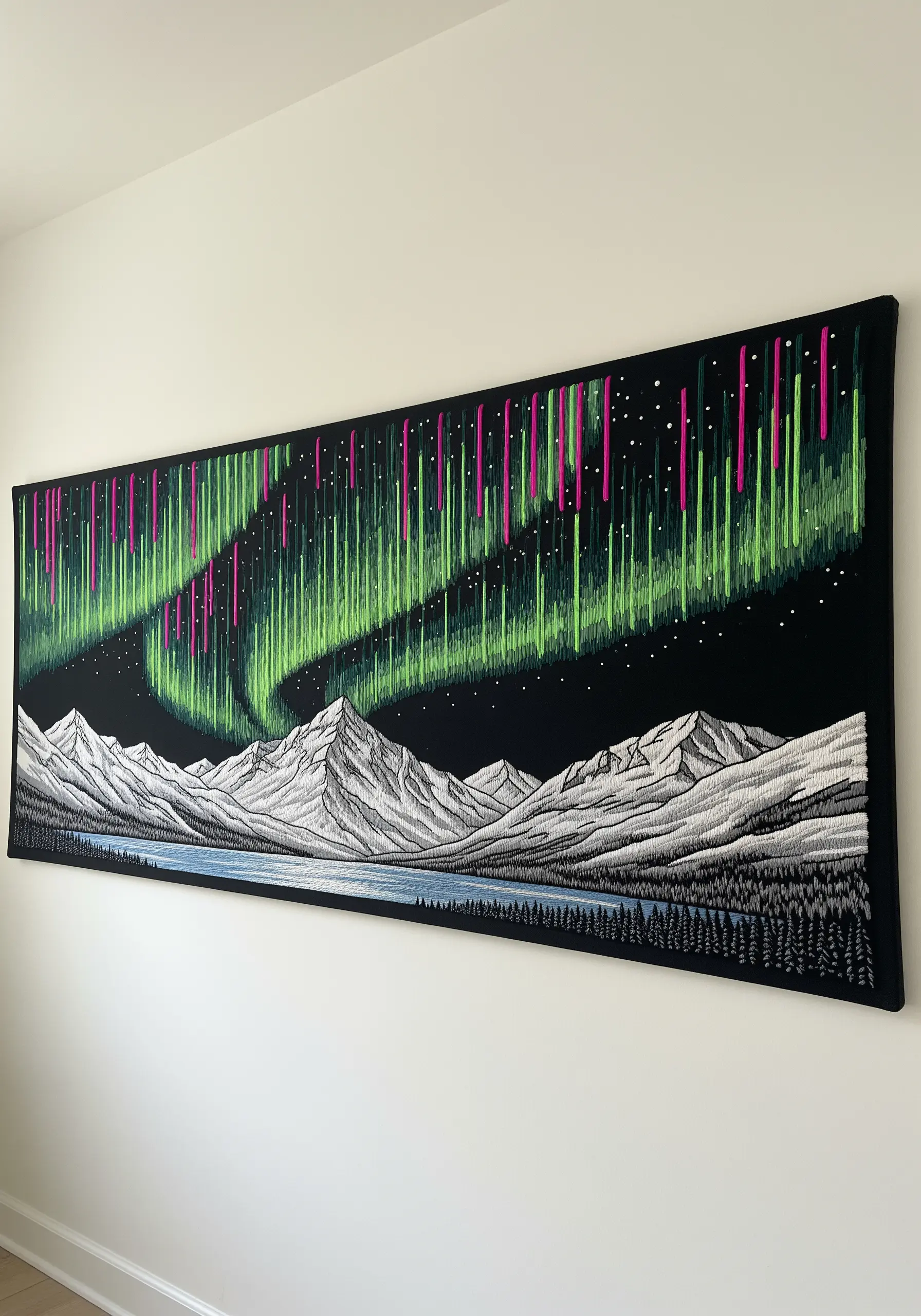 A large embroidered wall tapestry of the Northern Lights over a mountain range.