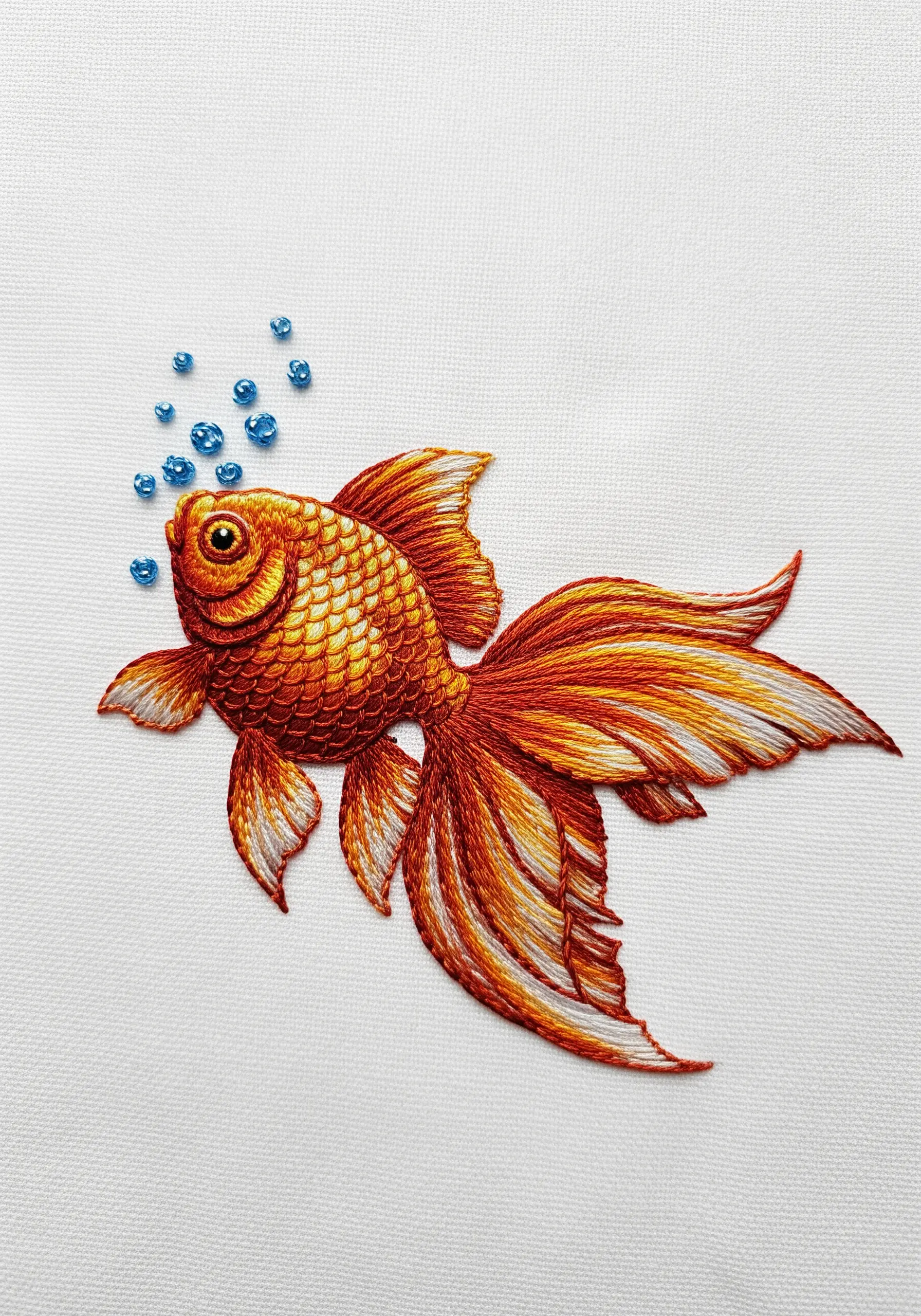 Goldfish embroidery with layered scalloped stitches for scales