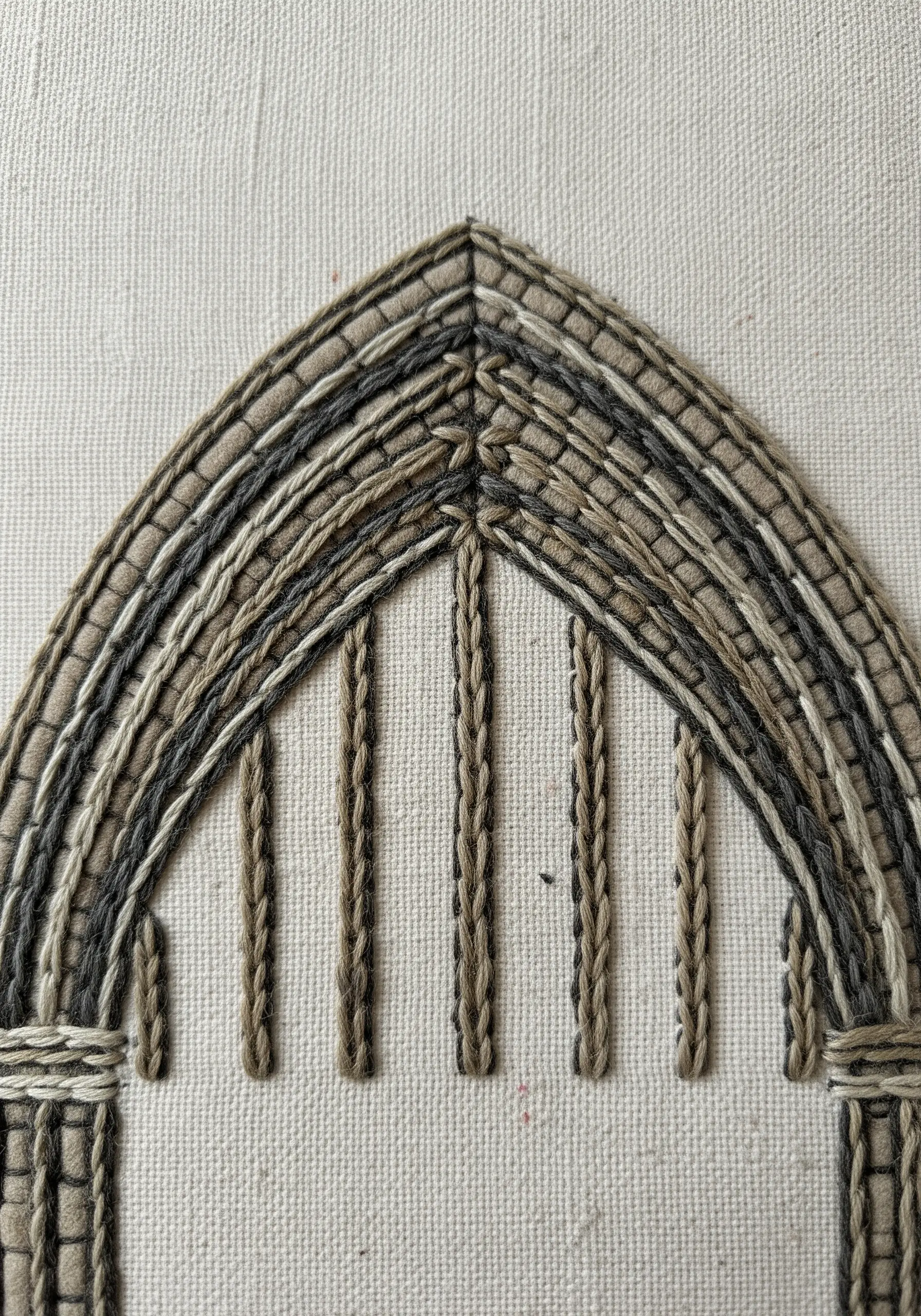 Textured chain stitch embroidery of a gothic arch