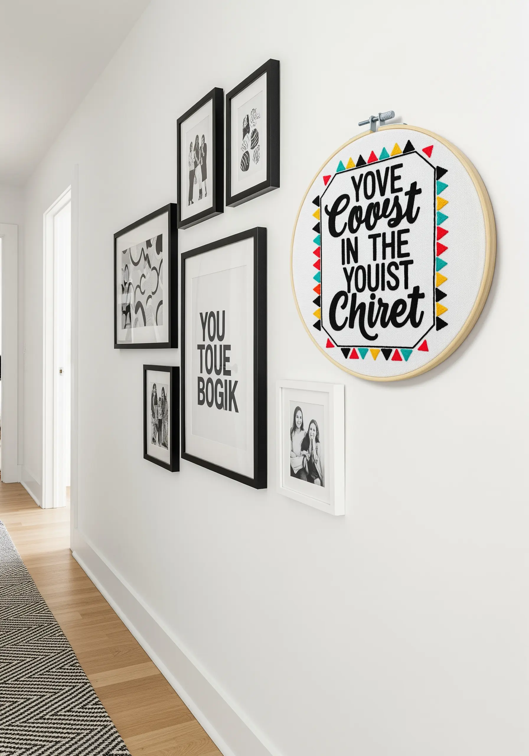 An embroidery hoop with bold black text and a colorful geometric border.