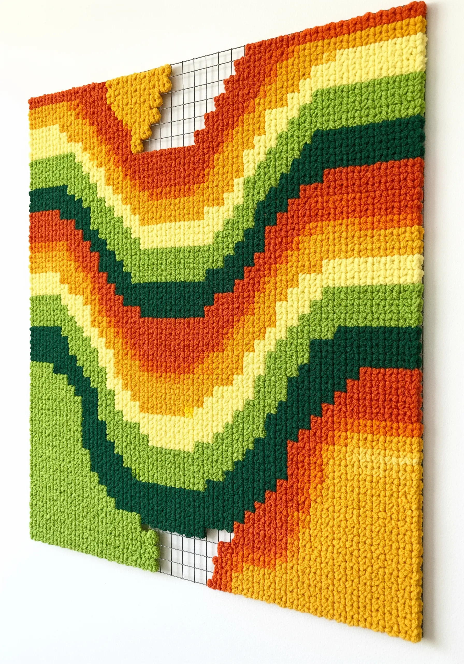 Colorful, wavy punch needle wall art created on a wire grid frame.