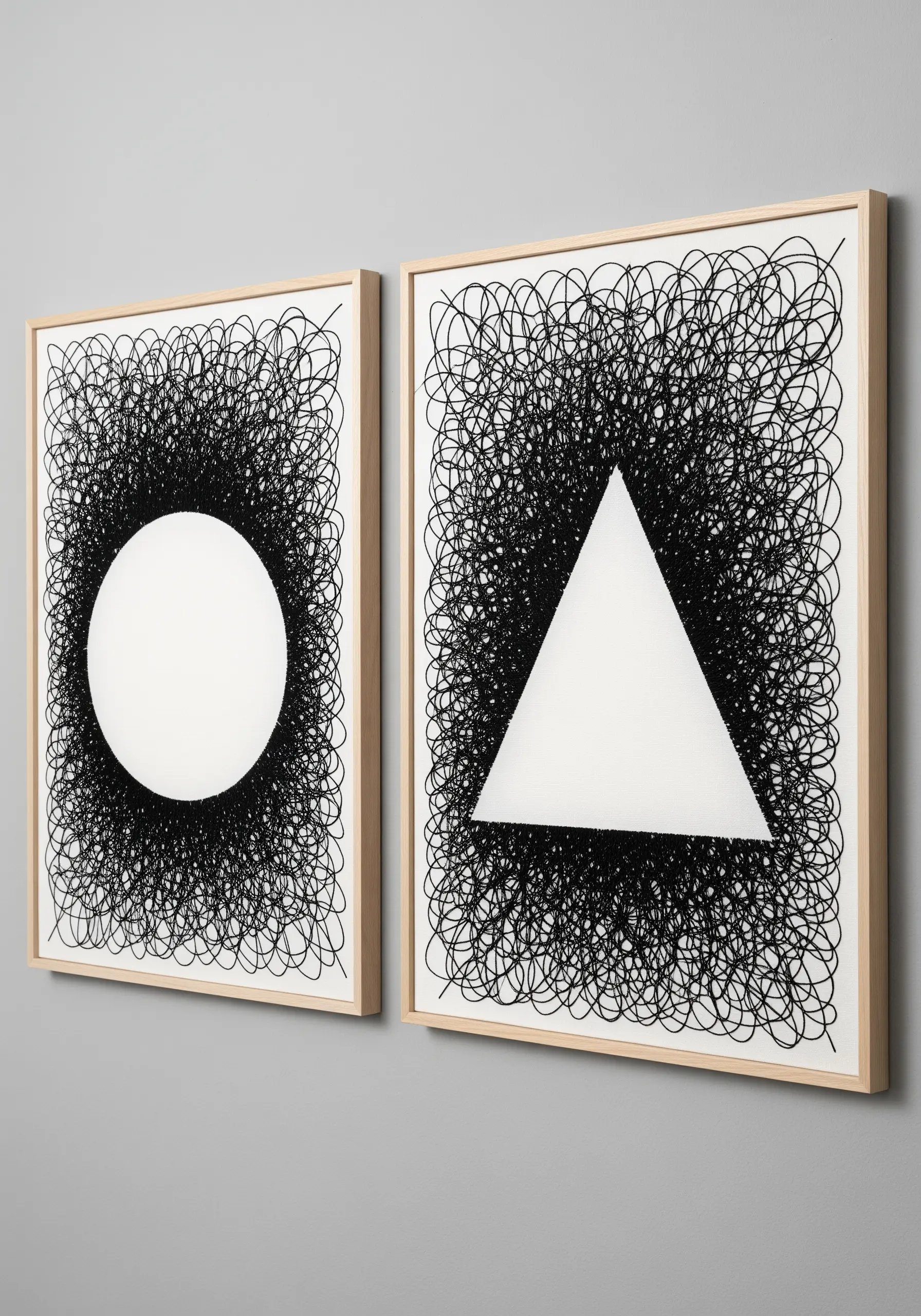 Two framed art pieces with chaotic black thread scribbles revealing a white circle and triangle.
