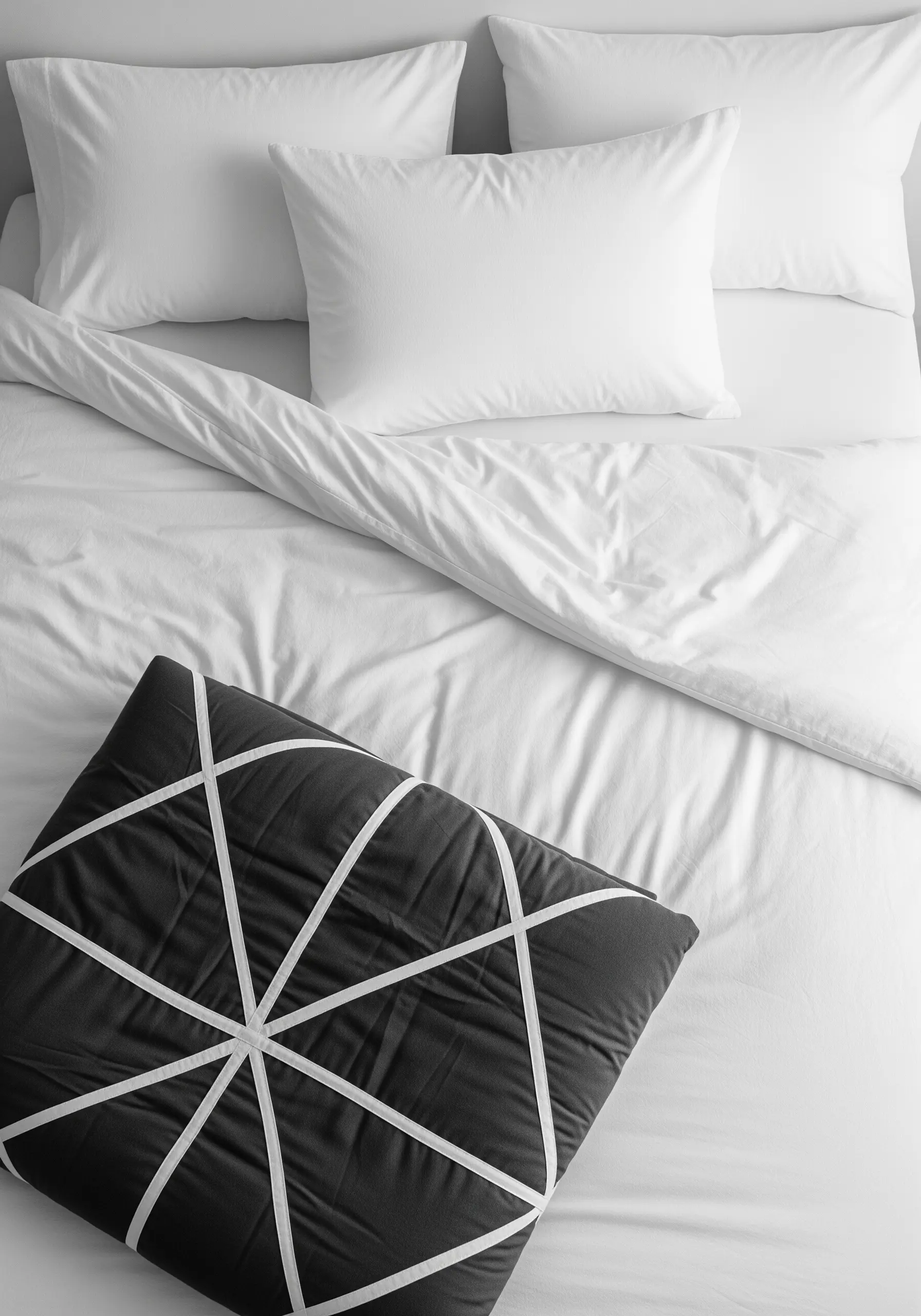 Black square pillow with white geometric line embroidery