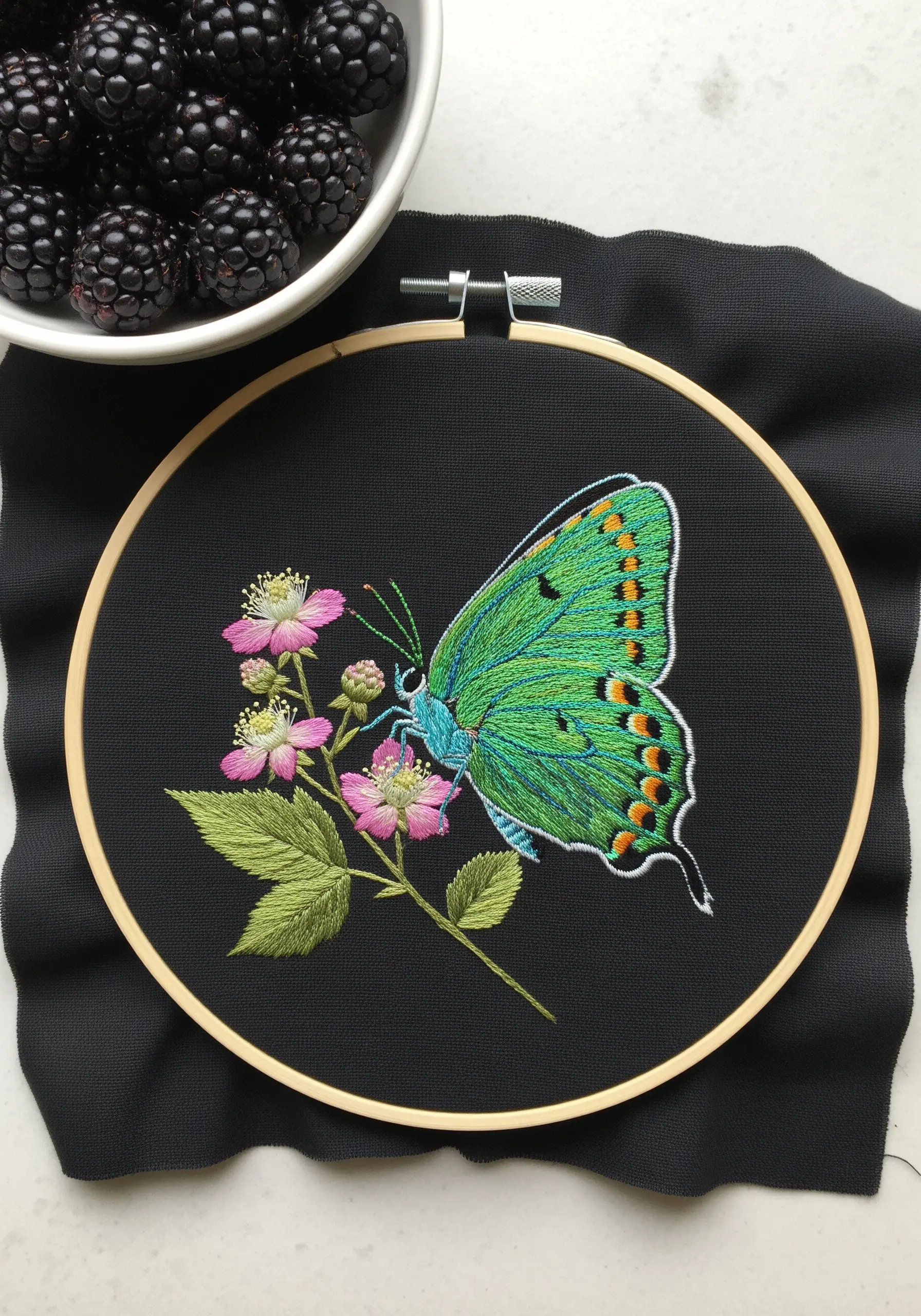 A vibrant green Tailed Jay butterfly on pink flowers, embroidered on black fabric.