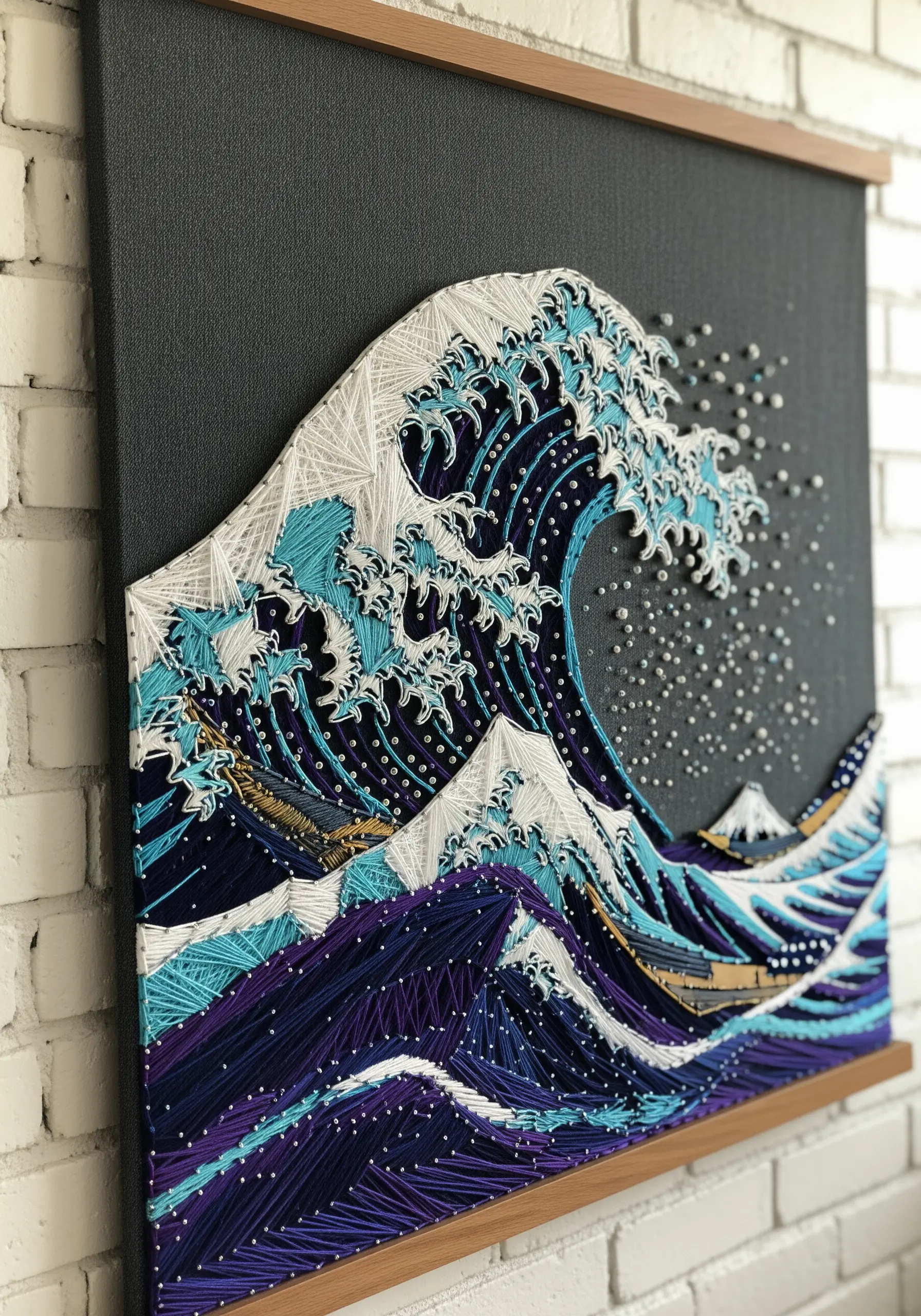 An intricate string art embroidery of The Great Wave with textured white foam.