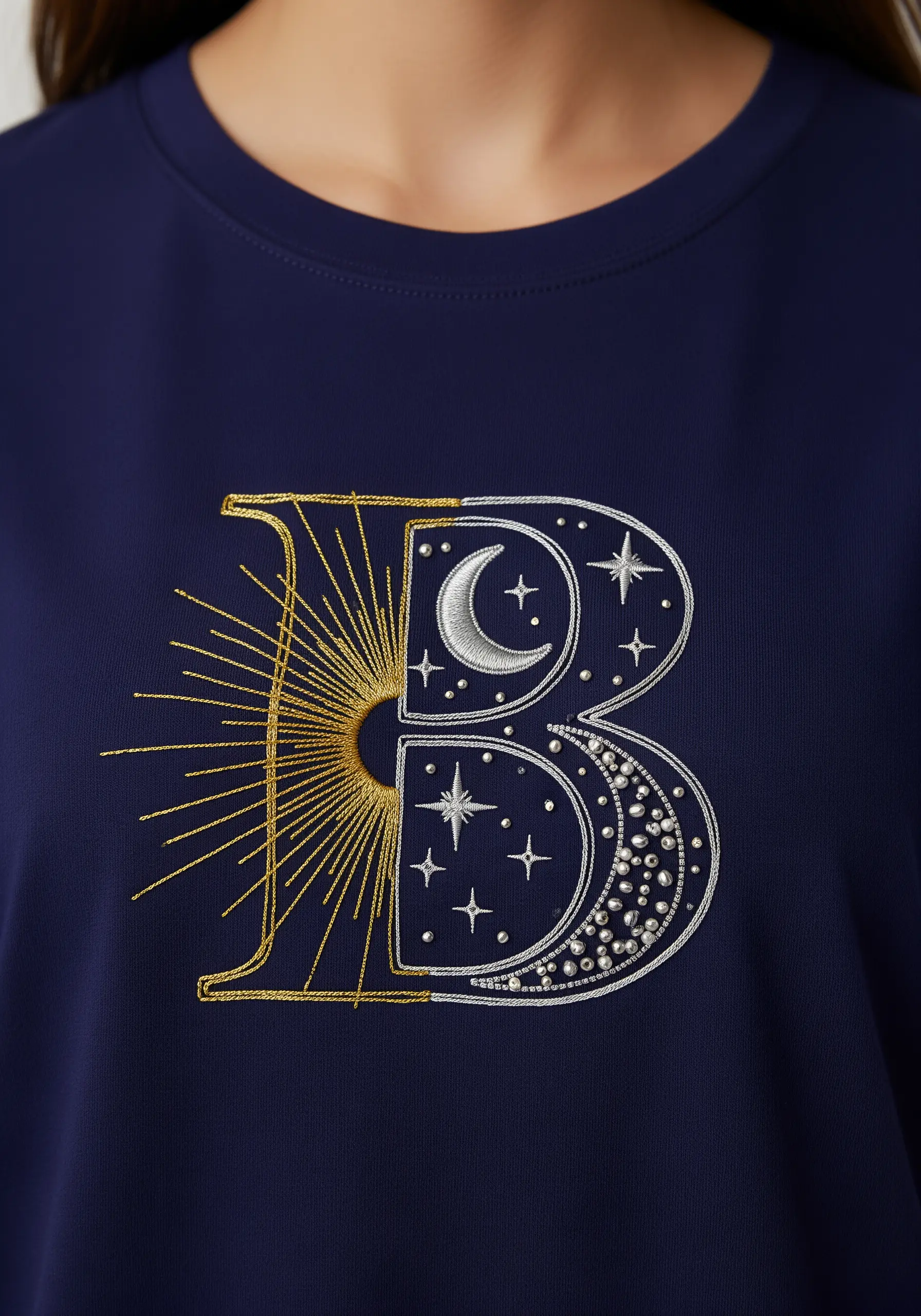 The letter 'B' is split in half: one side a gold sunburst, the other a silver moon and stars.