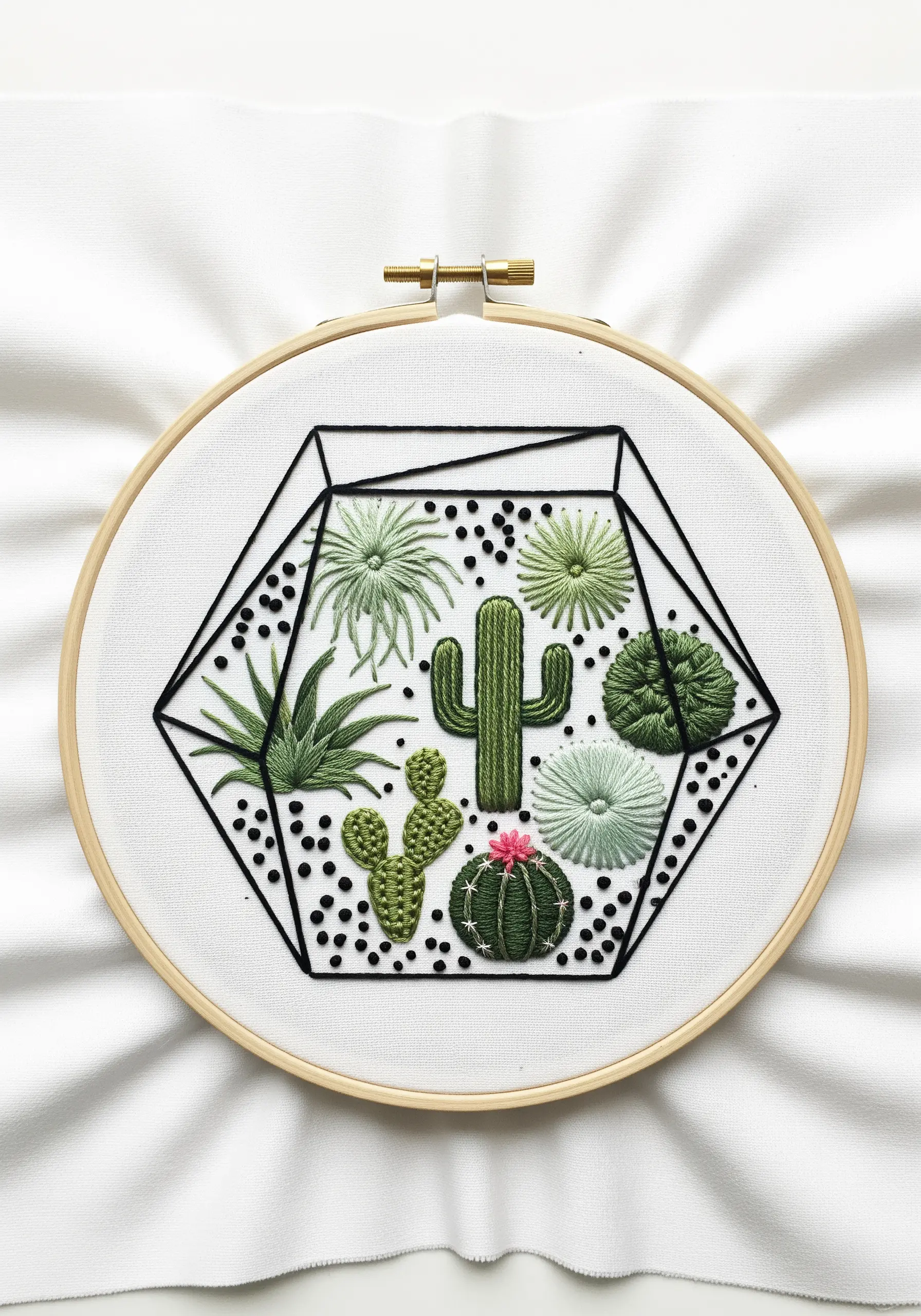 A geometric terrarium embroidery filled with various green cacti and succulents using different stitches.