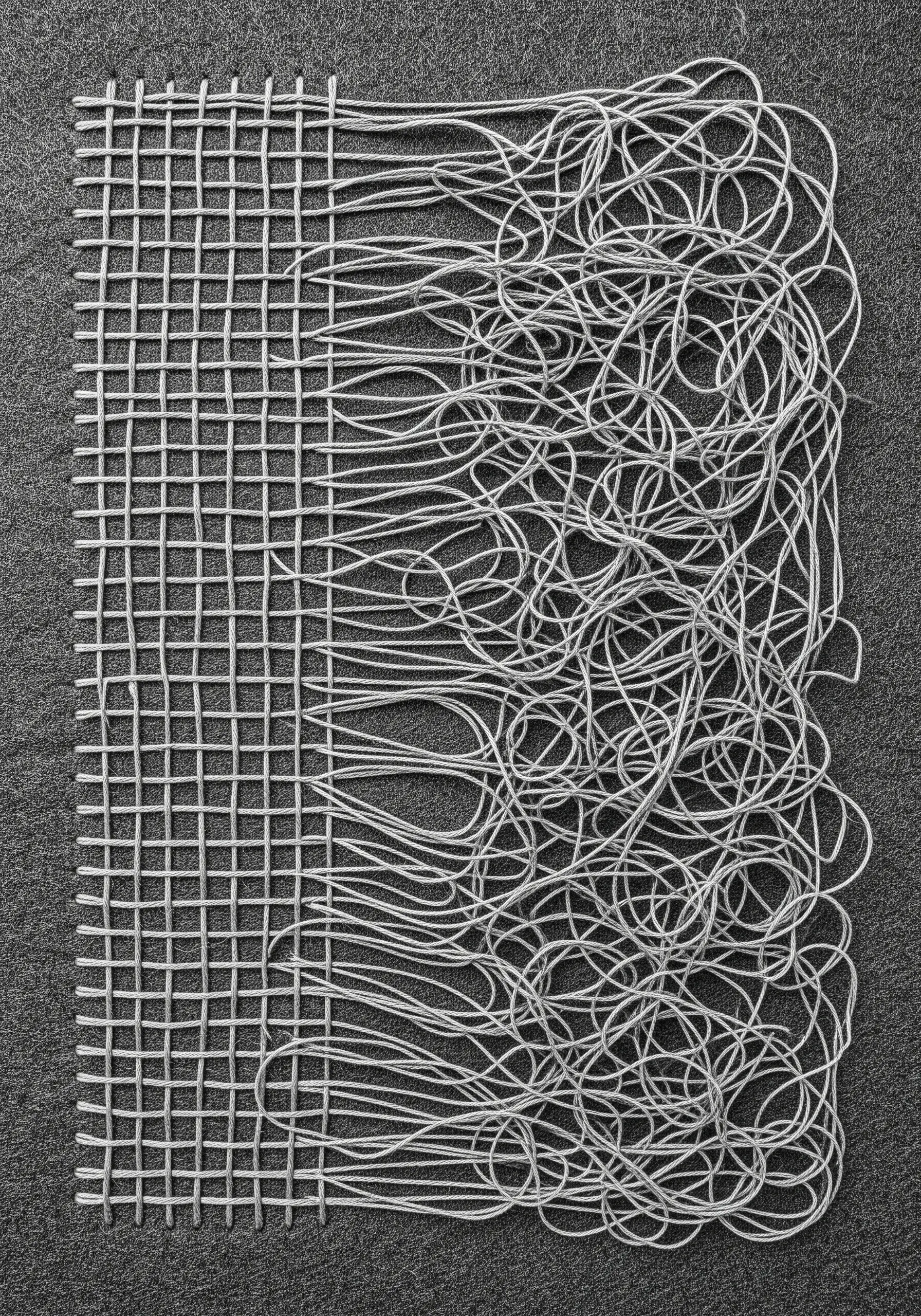 An abstract piece transitioning from an orderly silver grid to a chaotic tangle of threads.
