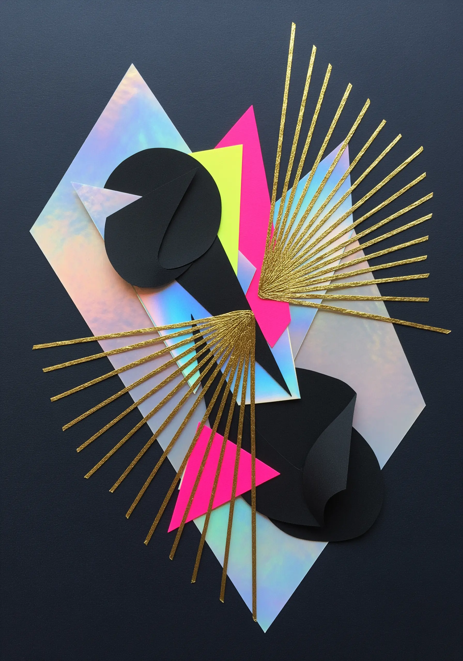 Abstract geometric paper collage with holographic, black, and gold elements.