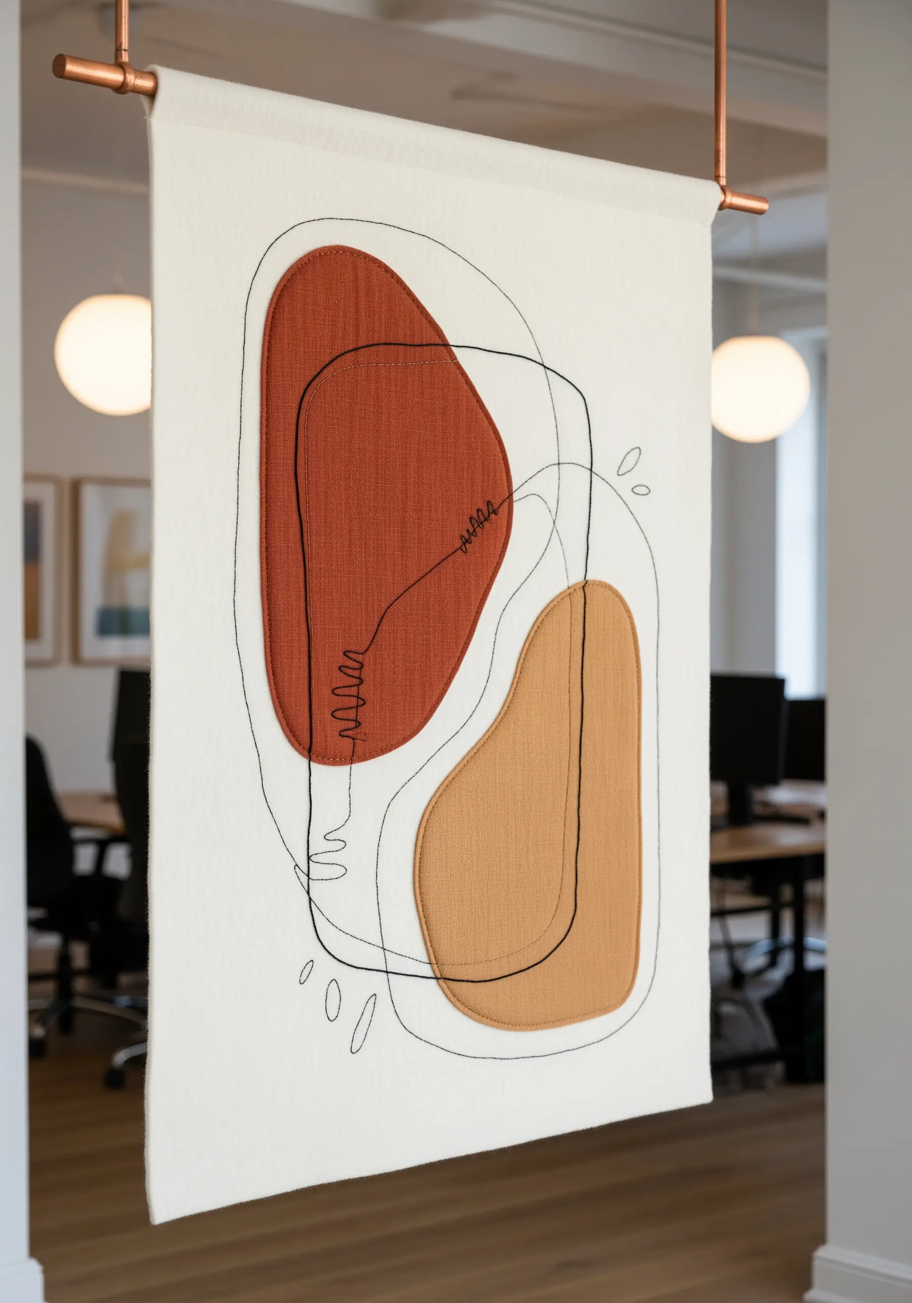 Abstract wall hanging combining embroidered lines with rust and tan fabric appliqué shapes.