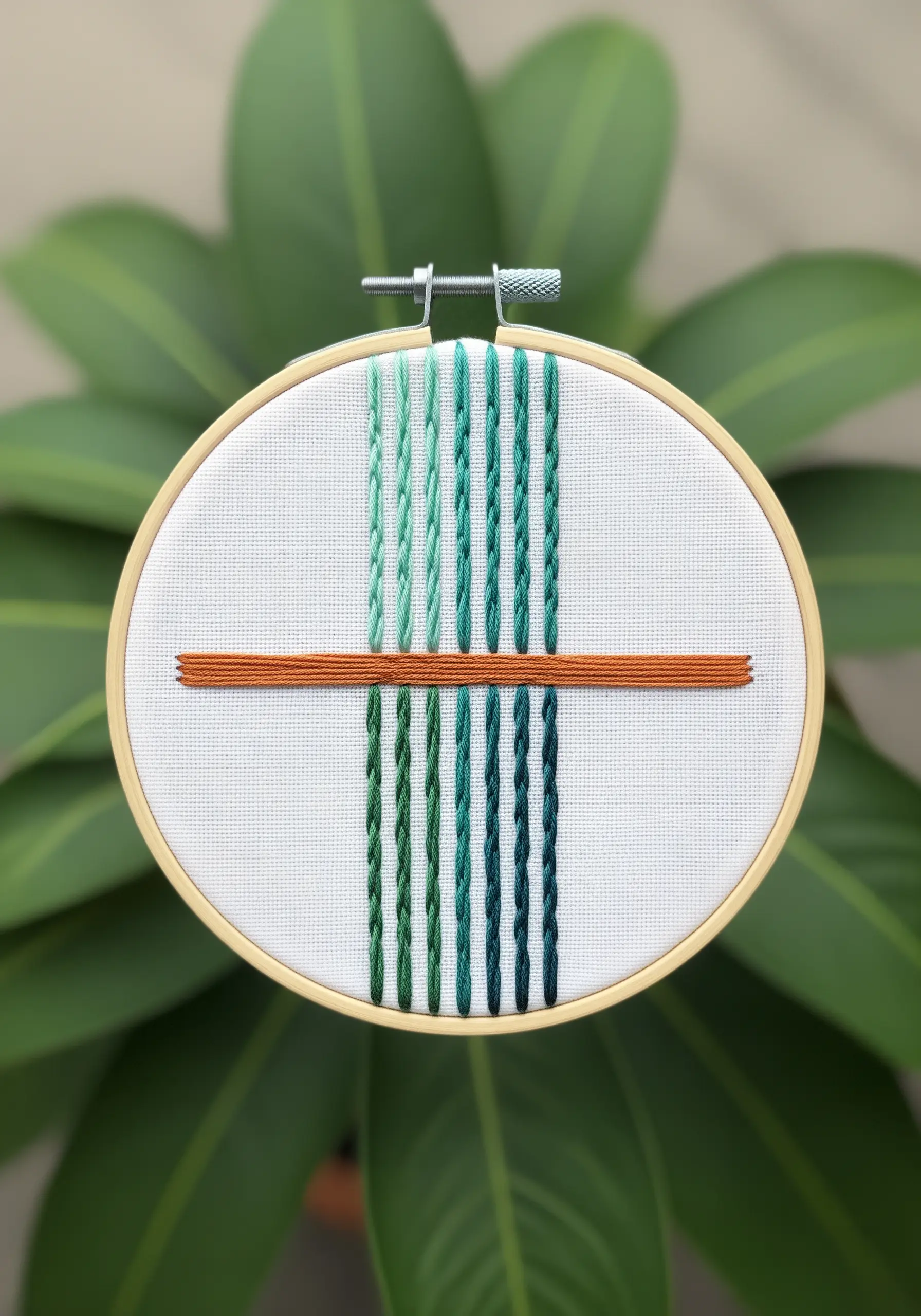 Abstract design with green gradient braid stitches and a horizontal terracotta satin stitch bar.