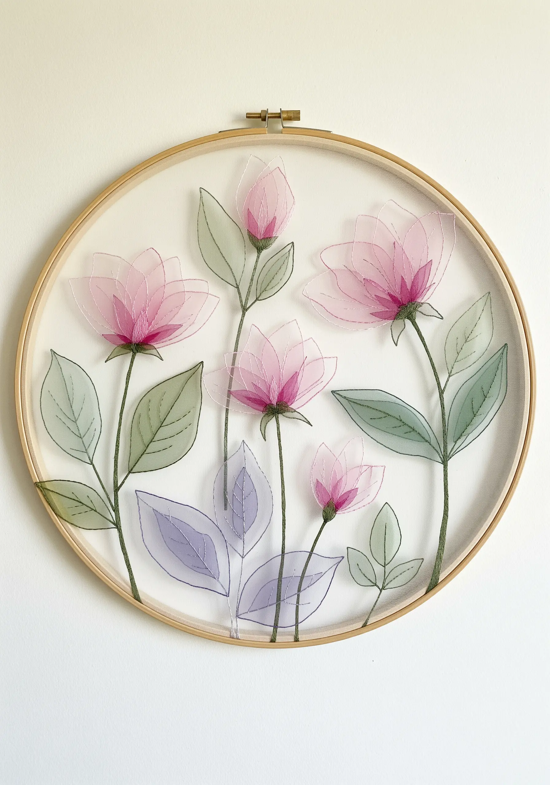 Sheer pink organza flowers stitched onto a transparent background in a hoop.