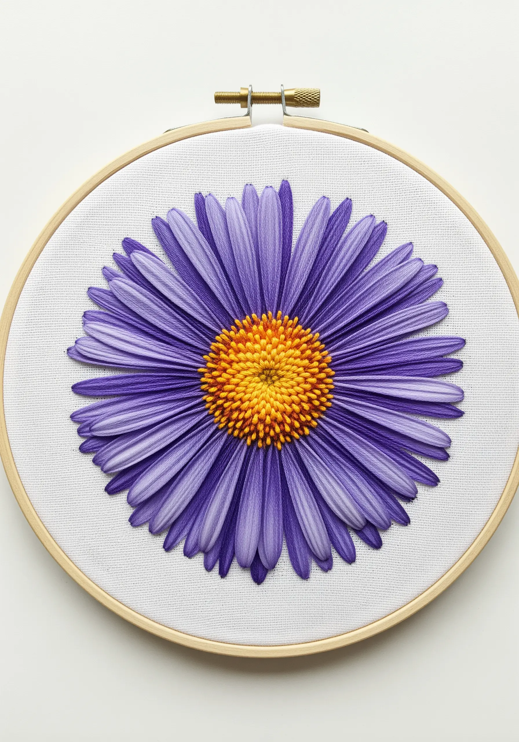 Purple aster flower with densely layered straight stitch petals and a yellow knotted center.