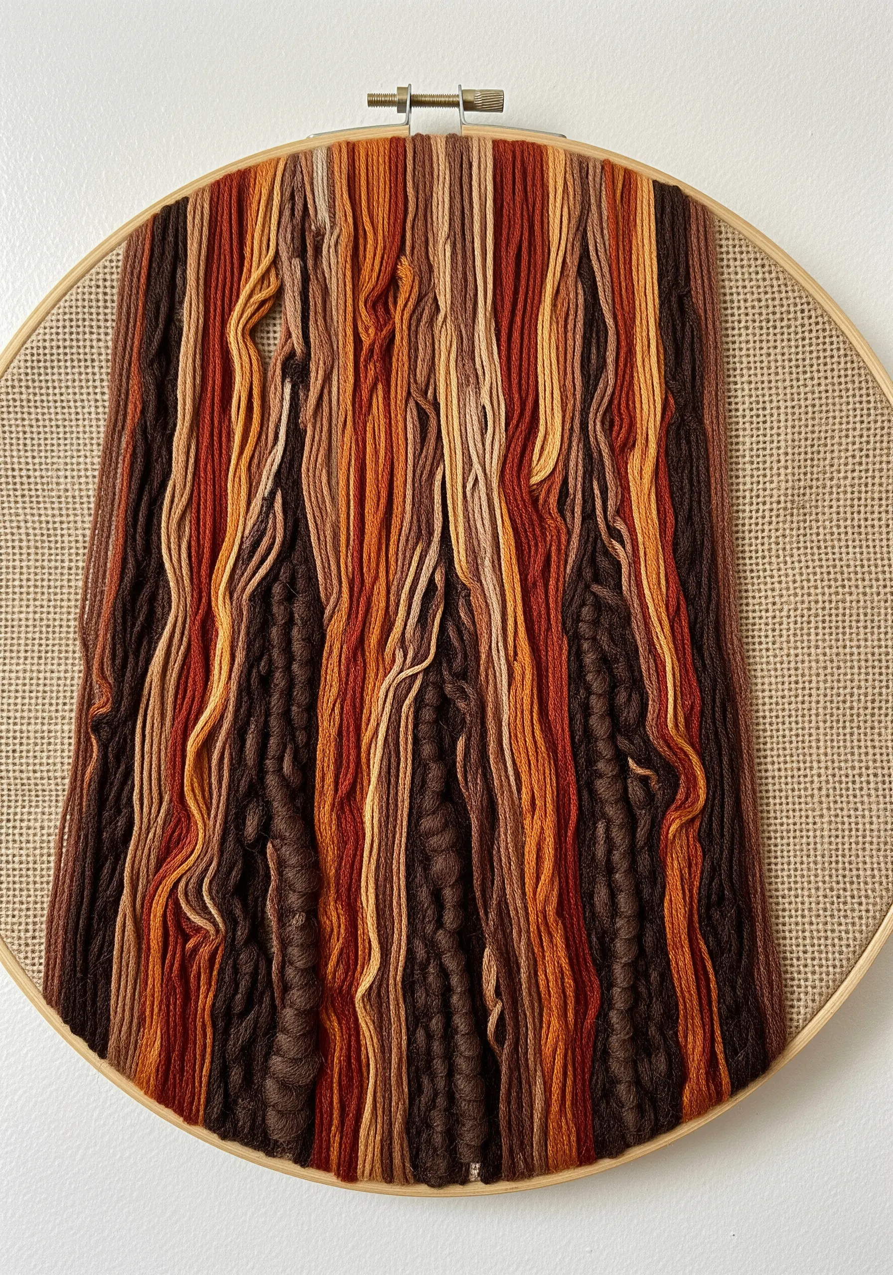 Close-up of heavily textured bark embroidery using thick yarns and earth-toned floss.