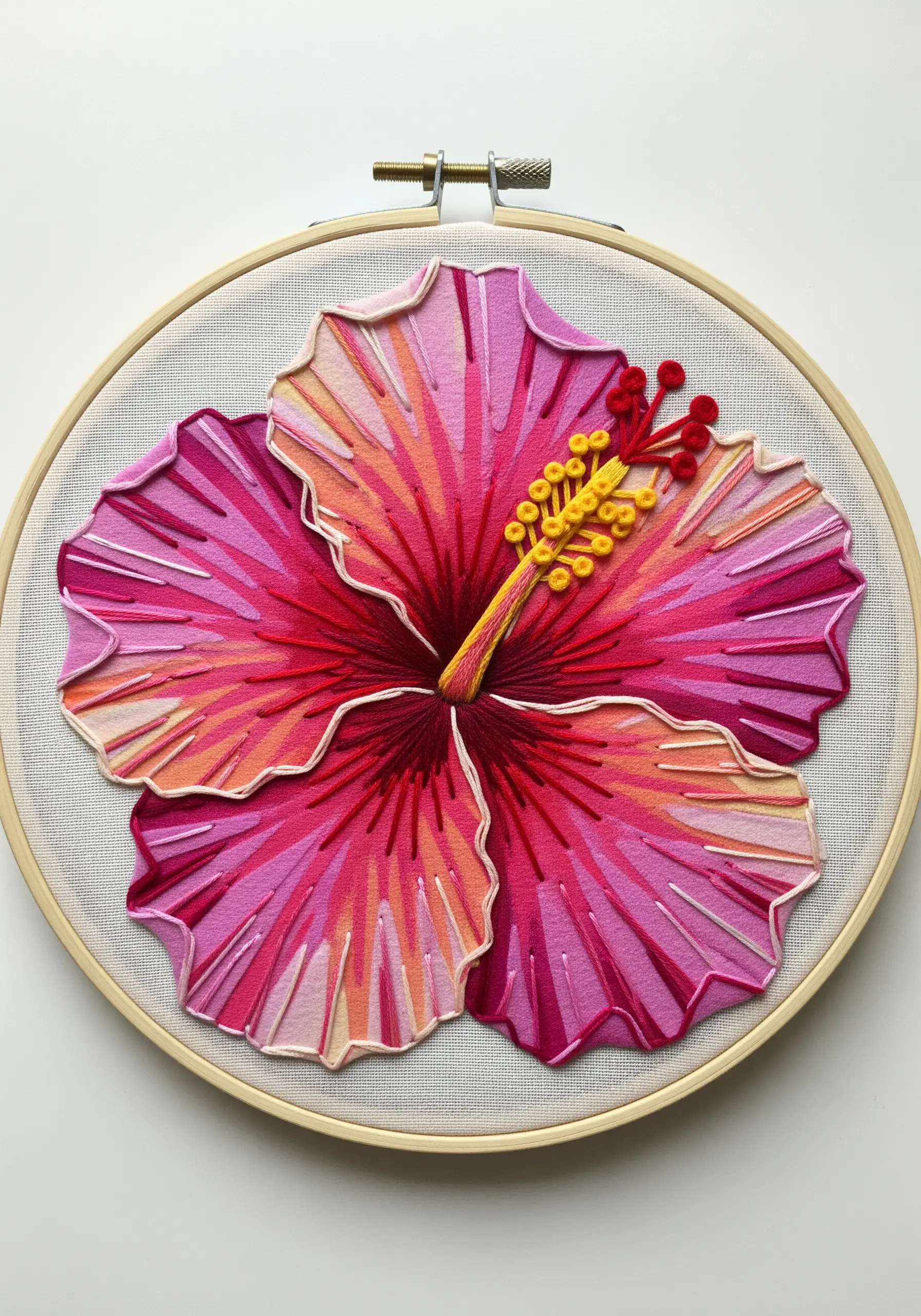 Layered appliqué hibiscus with directional satin stitching for depth and highlights.