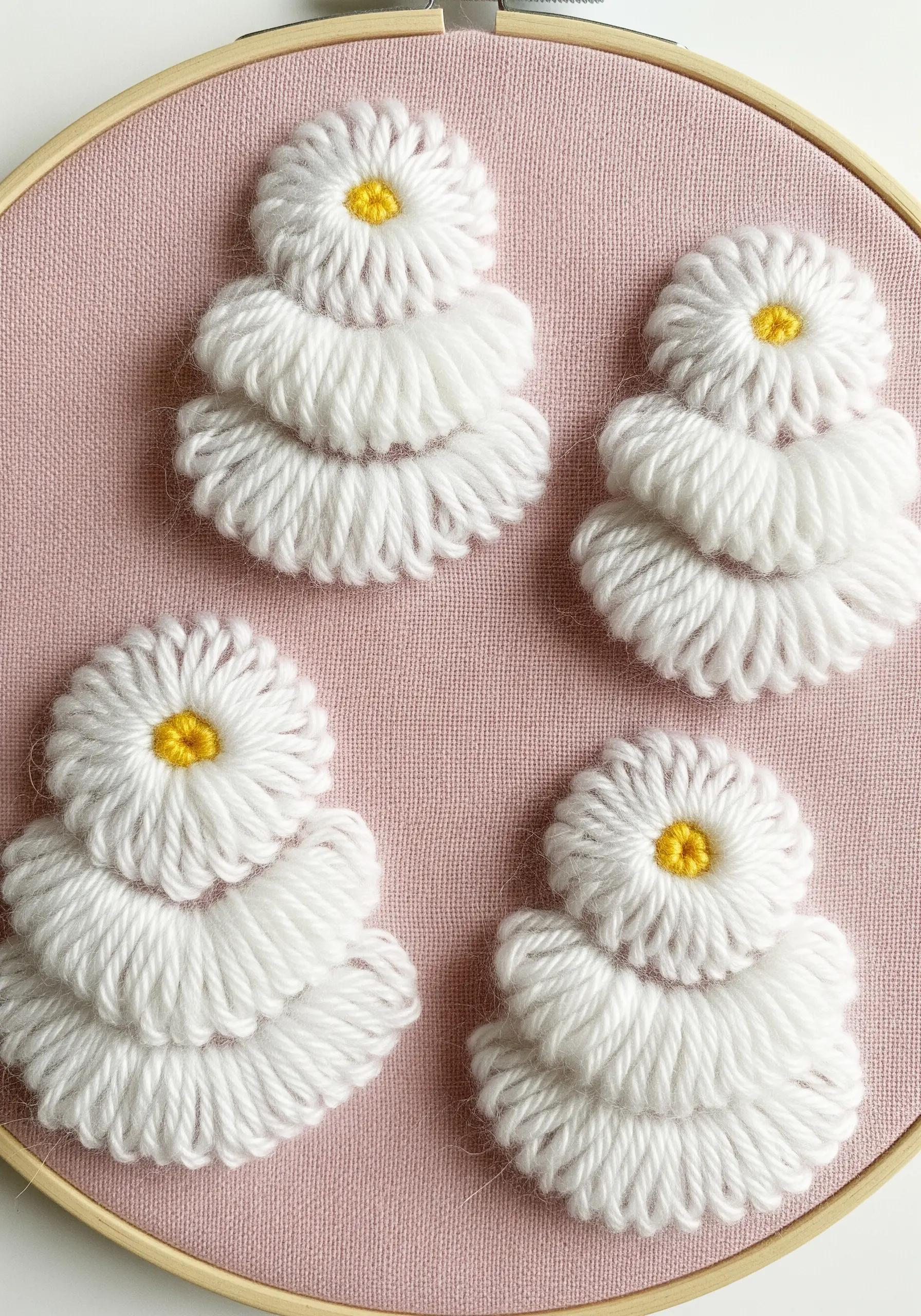 Fluffy, layered white thread forms with yellow centers on a pink background.