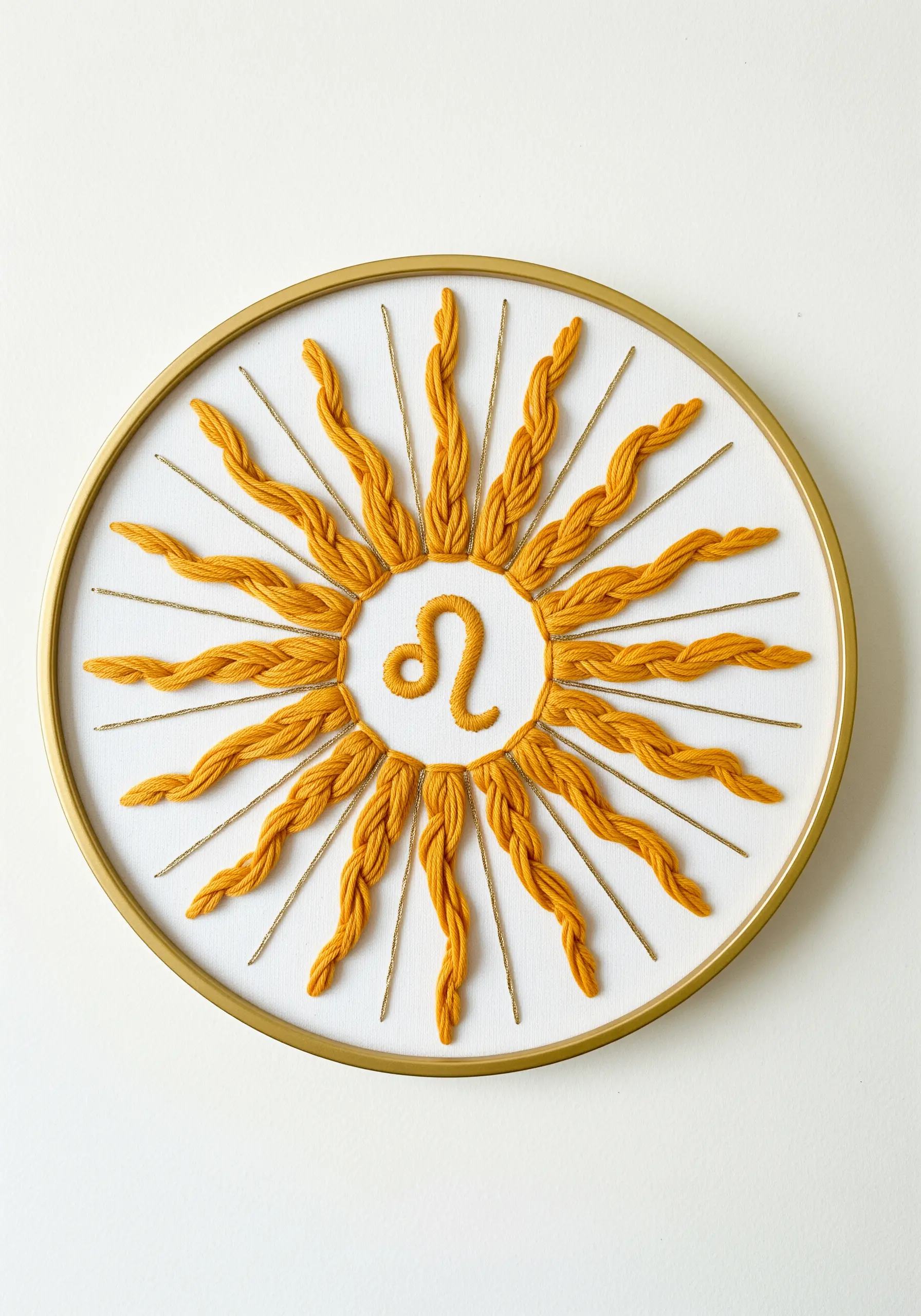 Leo sun symbol with sun rays made from thick, braided yellow yarn and gold cord.