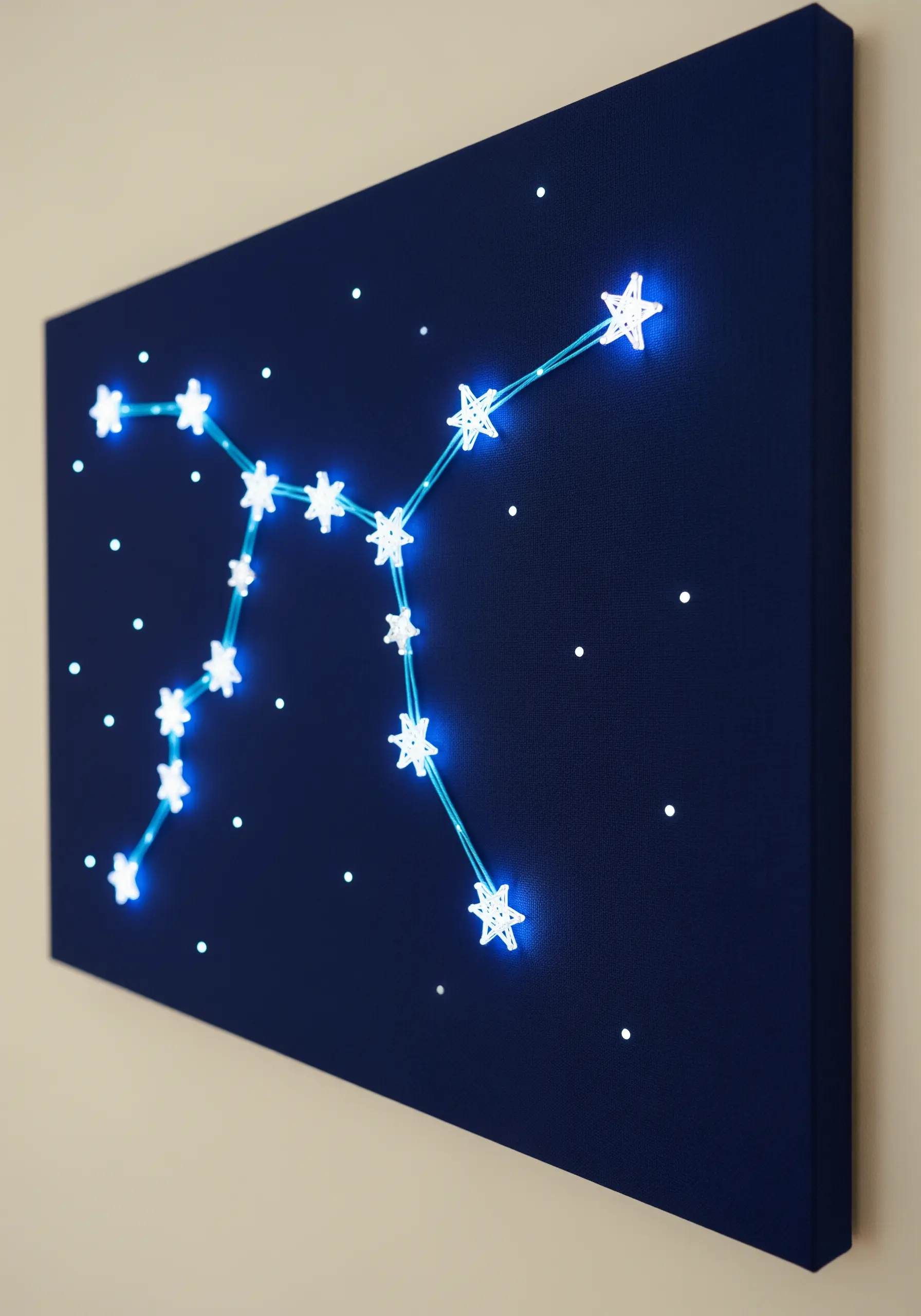 An embroidered constellation on dark blue canvas with glowing stars connected by turquoise lines.