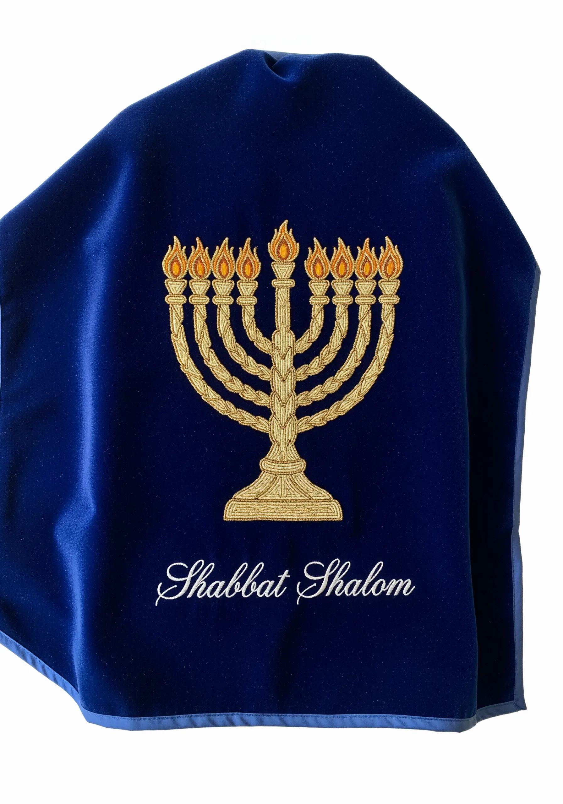 A gold embroidered menorah on a royal blue velvet challah cover.