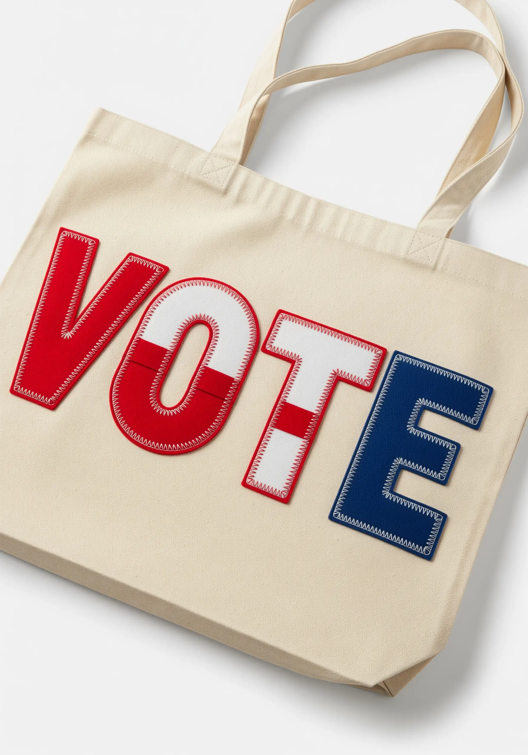 The word 'VOTE' in red, white, and blue appliqué letters stitched onto a tote bag.