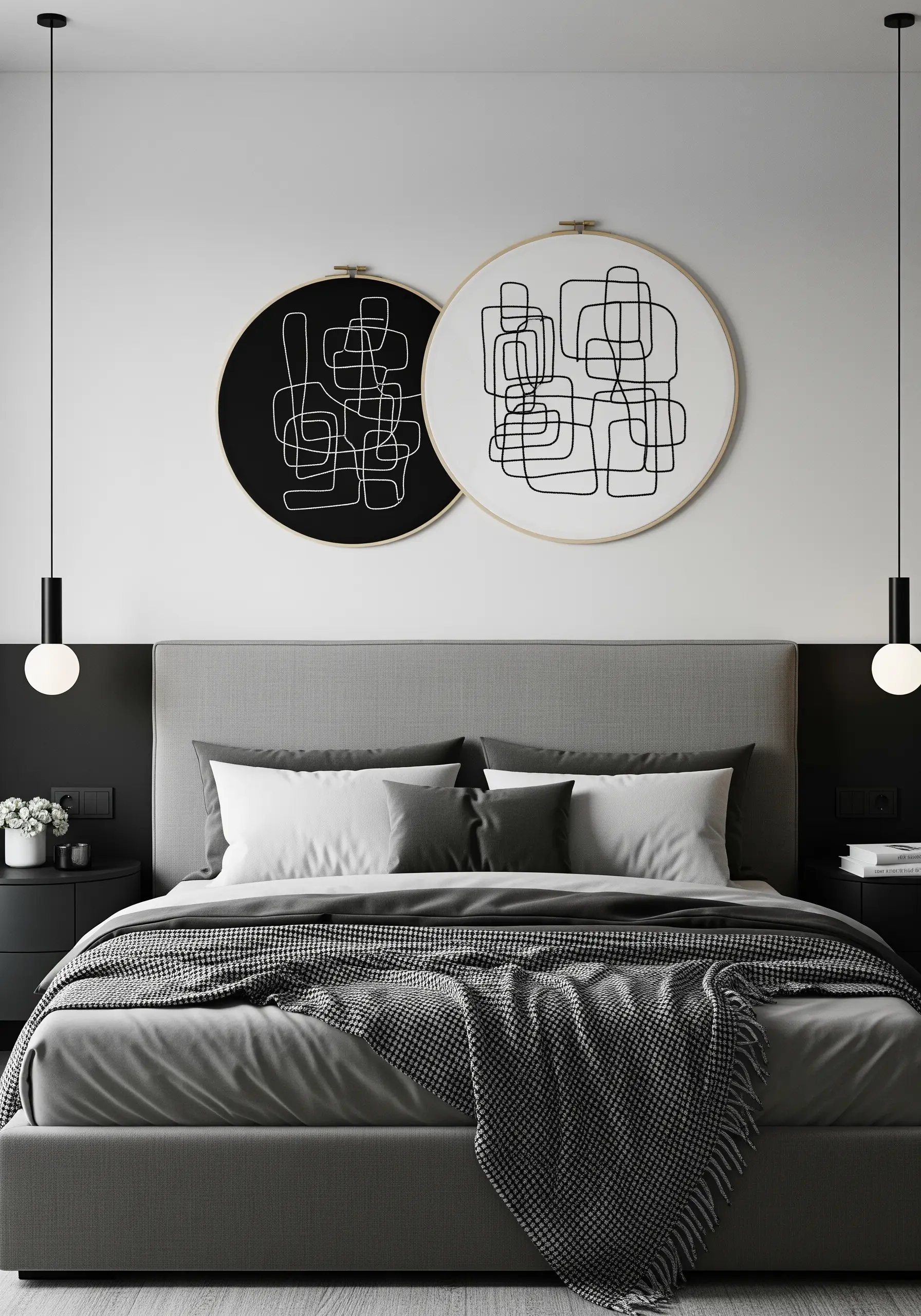 Two large hoops with abstract, continuous-line art, one black on white and one white on black.