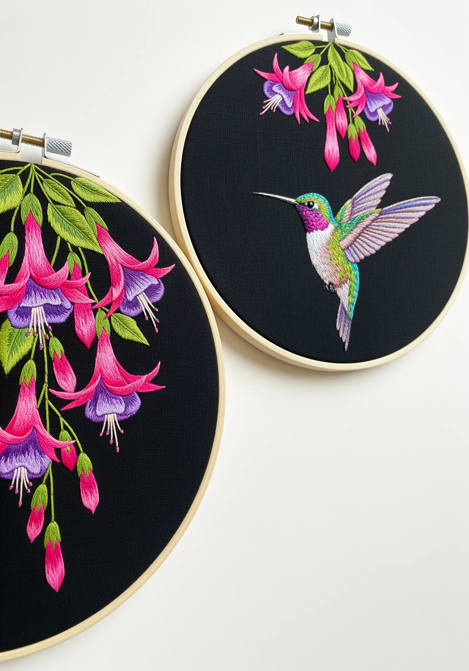 A hummingbird and fuchsia flowers embroidered with vibrant colors on black fabric.