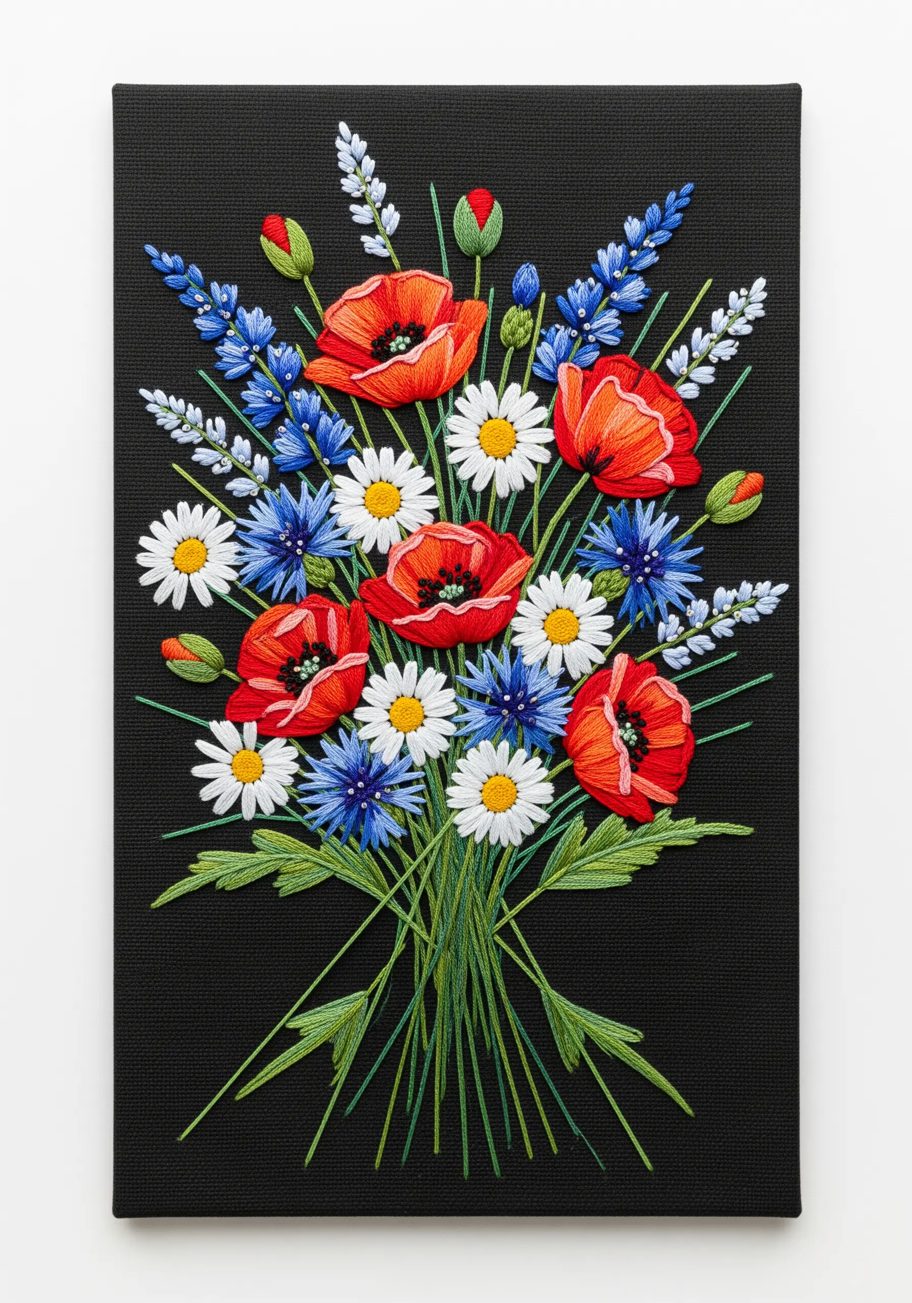 A vibrant embroidered bouquet of red poppies, blue cornflowers, and white daisies on black canvas.