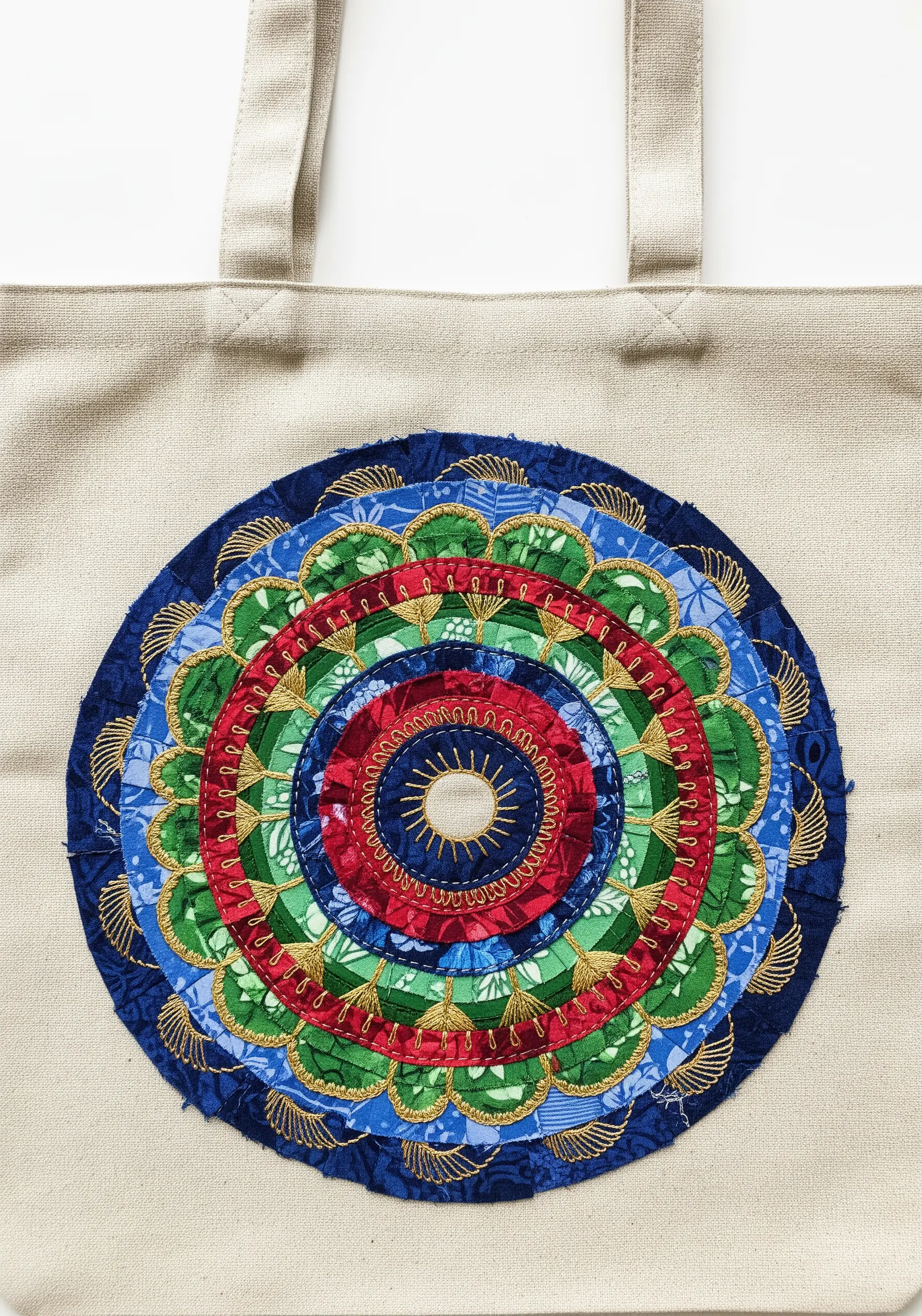 Colorful fabric mandala with layered, ruffled textures and gold thread details on a tote.