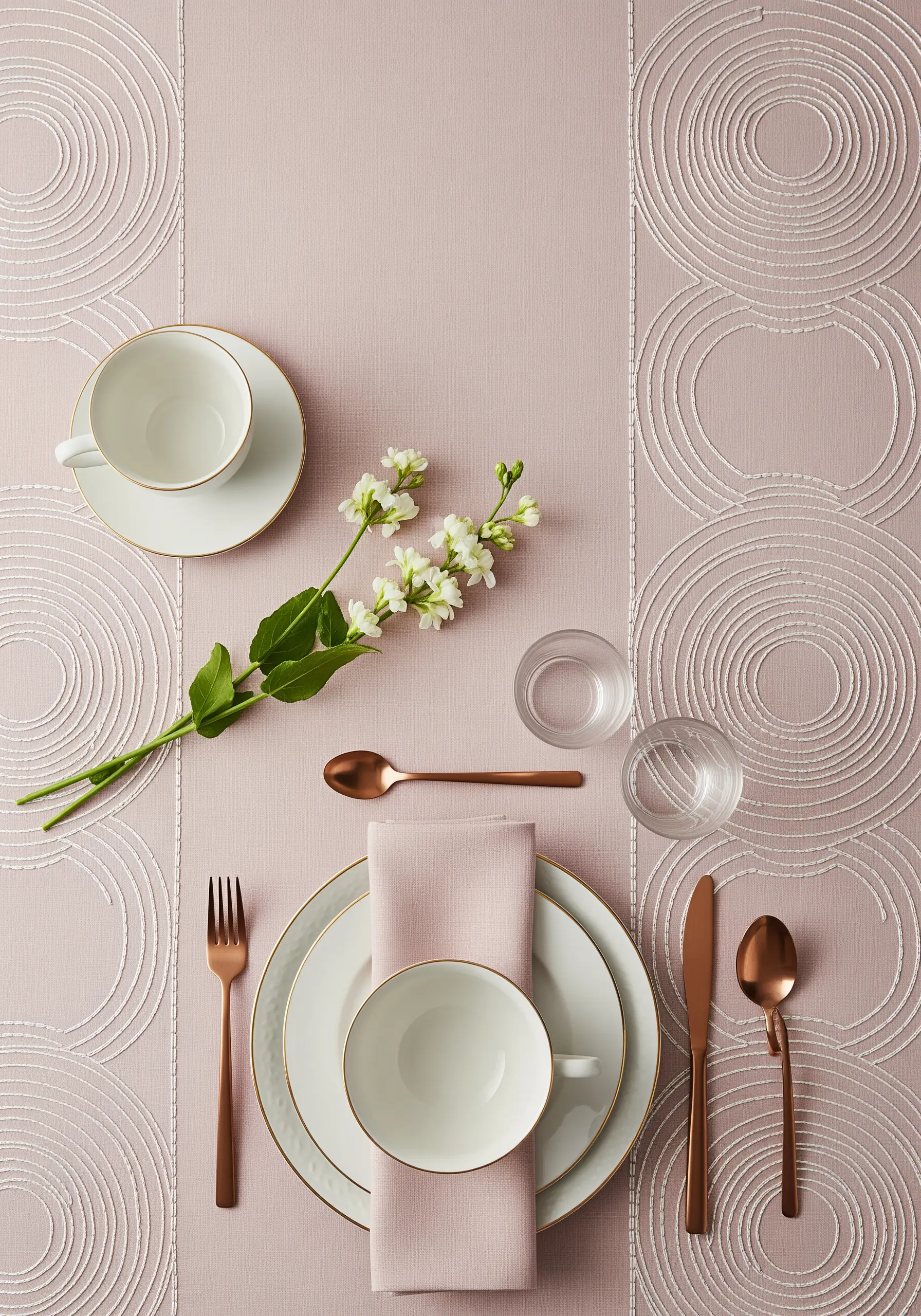 Dusty pink table runner with embroidered white concentric circles