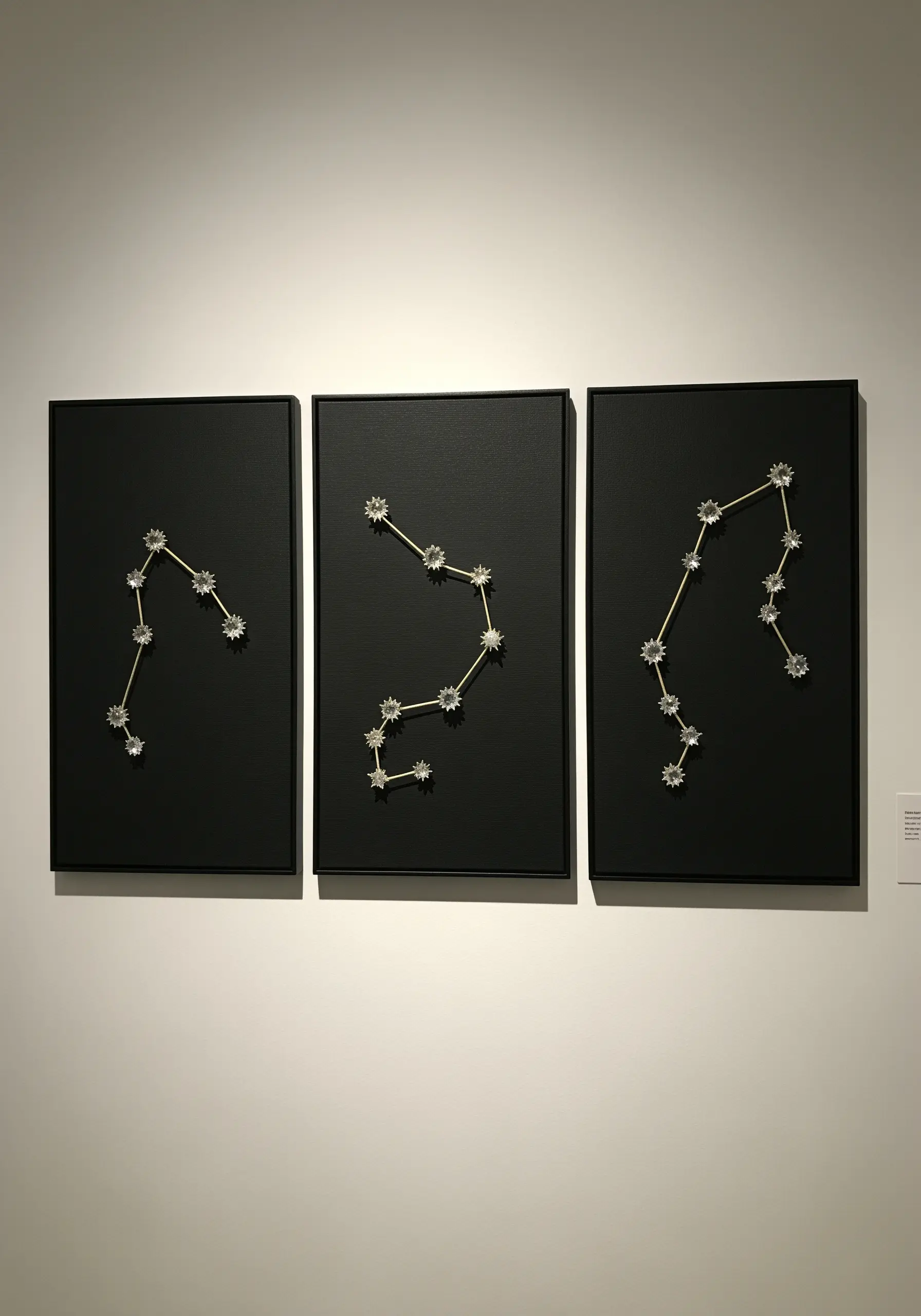 A triptych of three black panels, each showing a constellation made with beads.