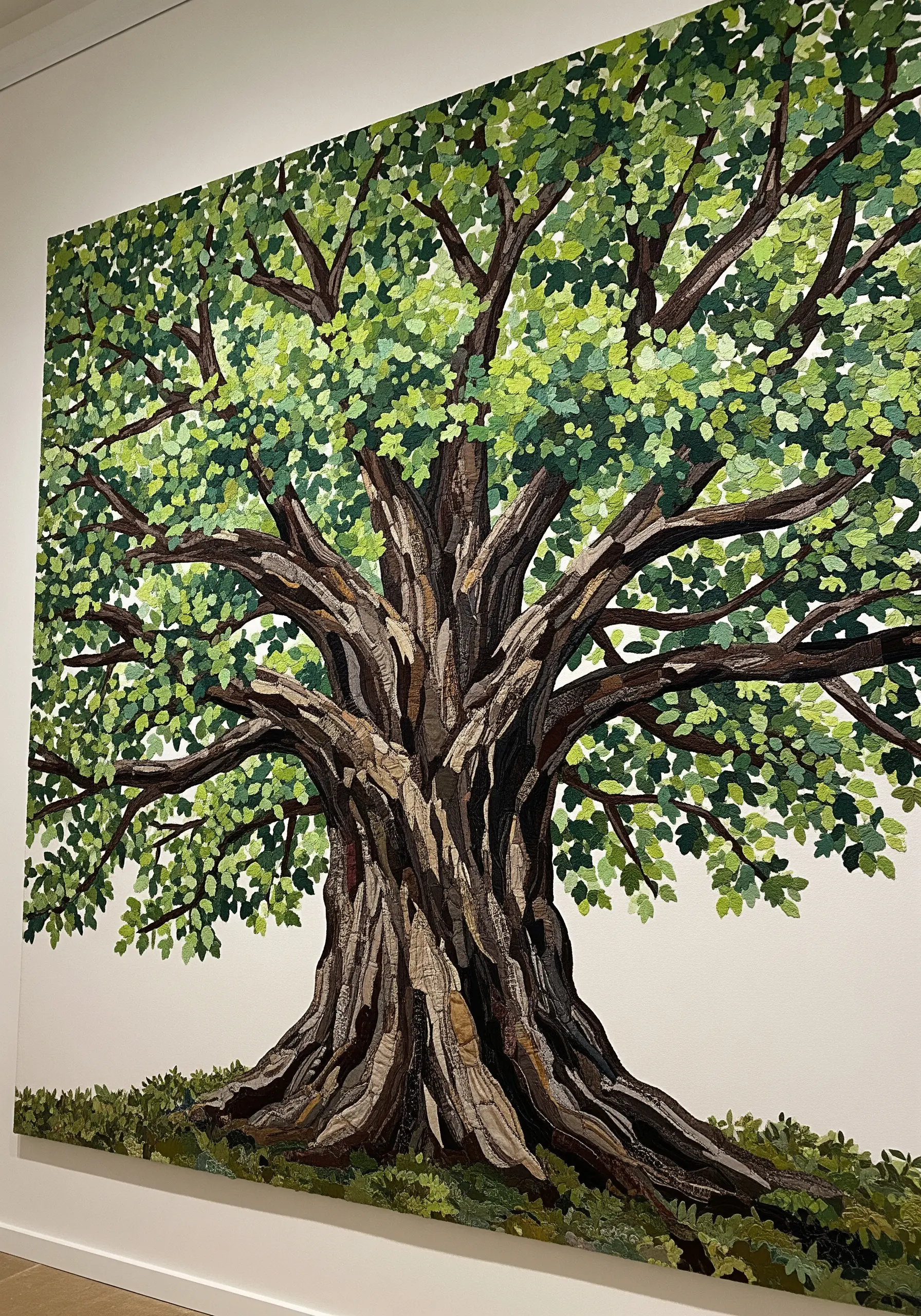 Close-up of a large tree trunk made from mosaic-style fabric appliqué.