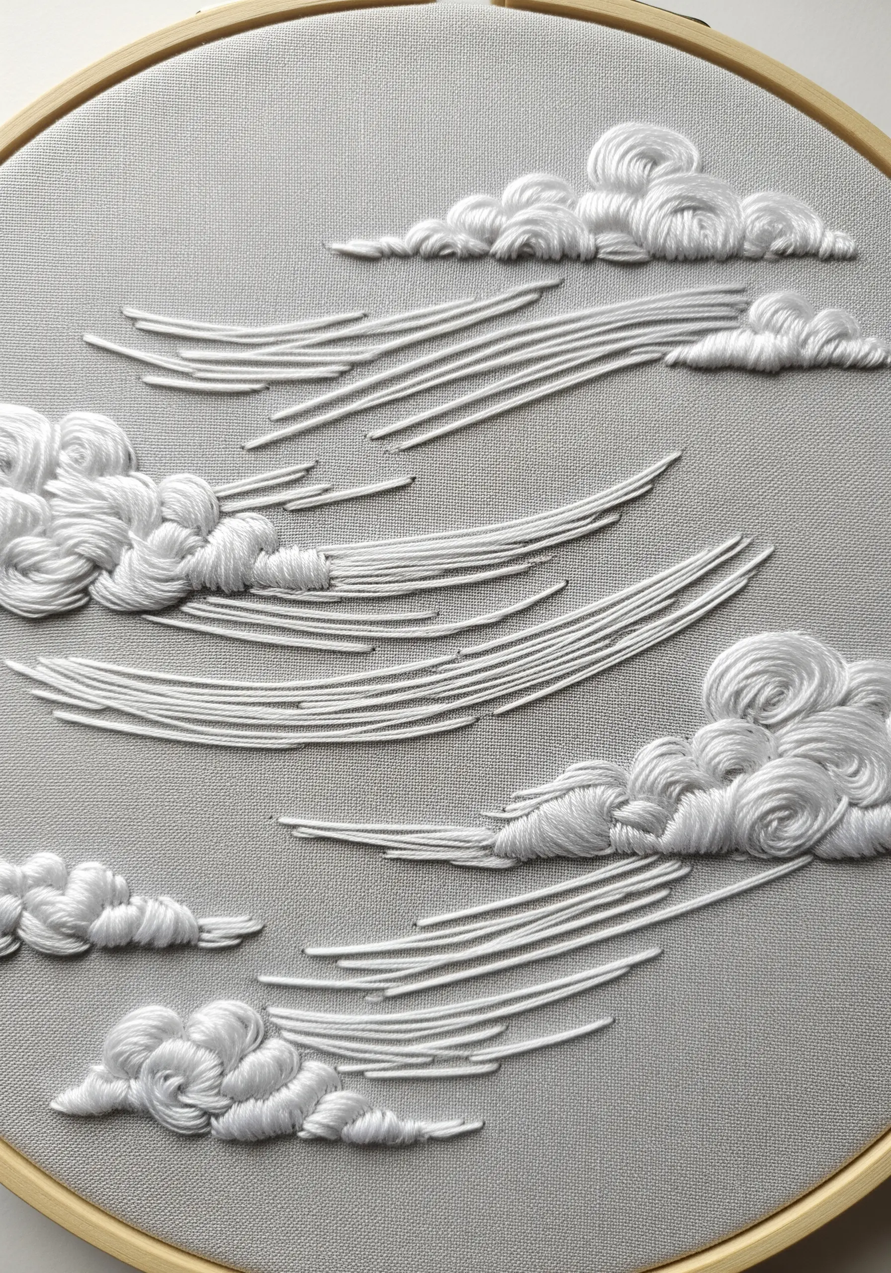 White sweeping wind lines embroidered on grey fabric