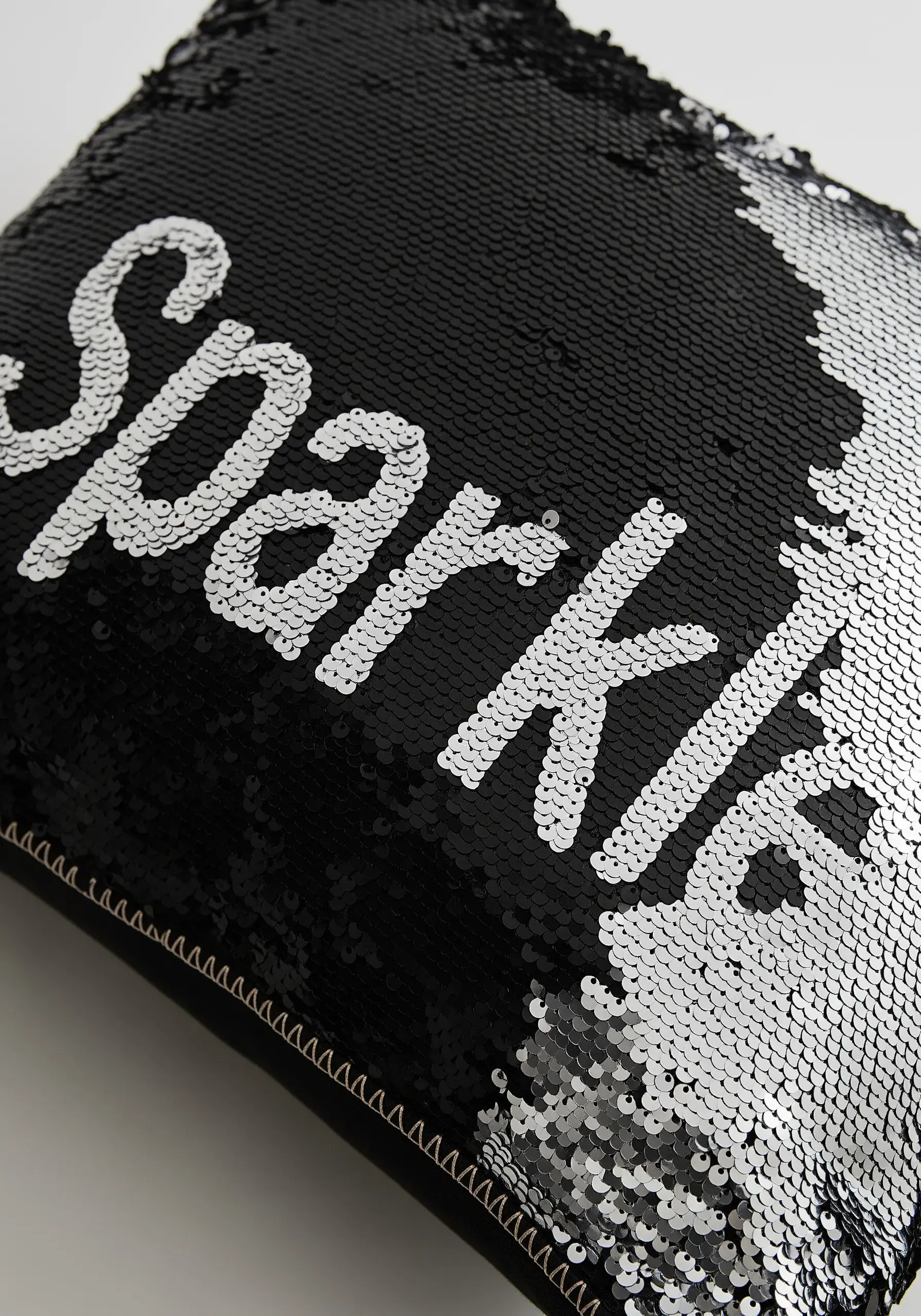 Black sequin cushion with silver sequin word Sparkle
