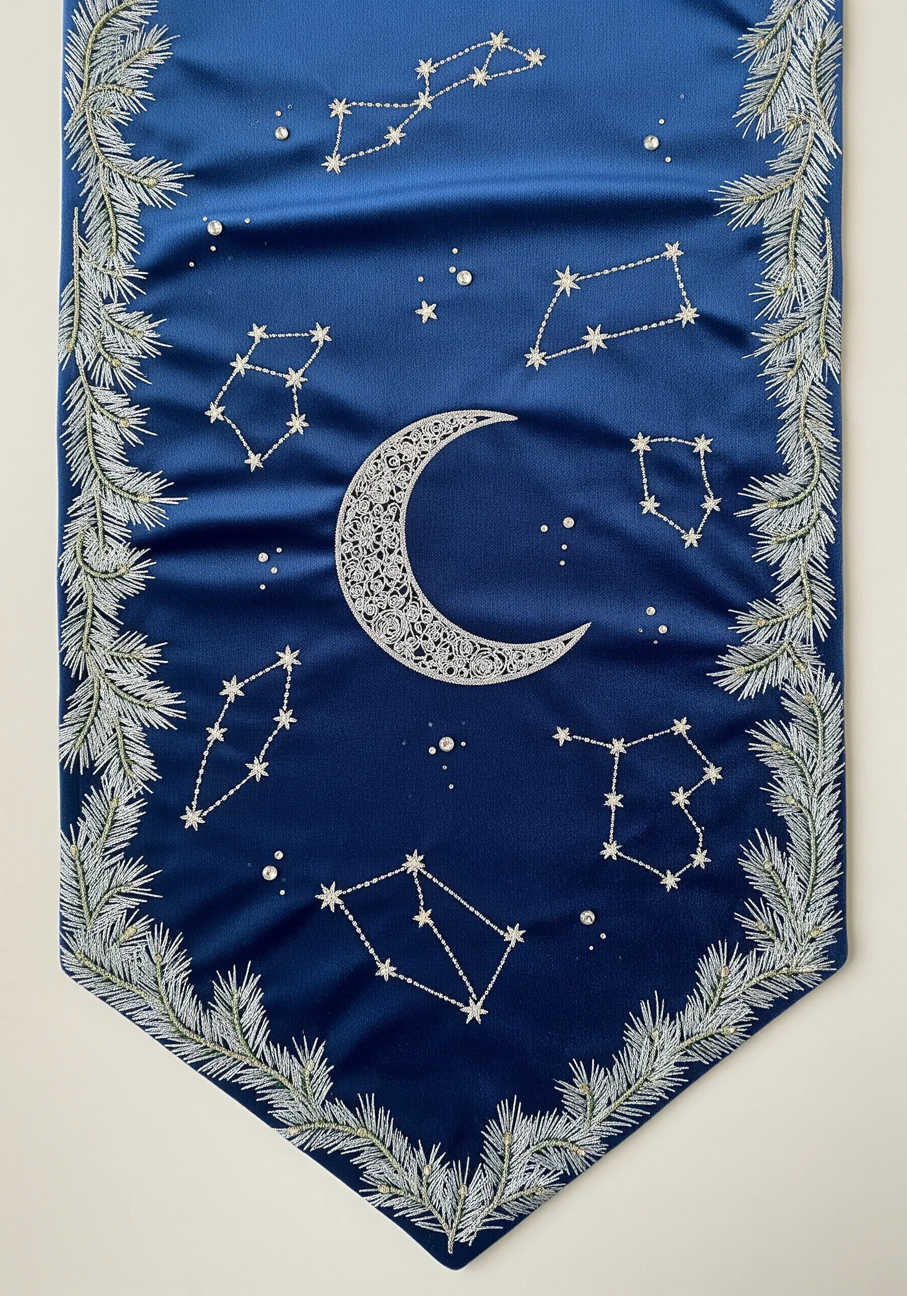 Embroidered crescent moon and constellations with beadwork on a royal blue satin runner.