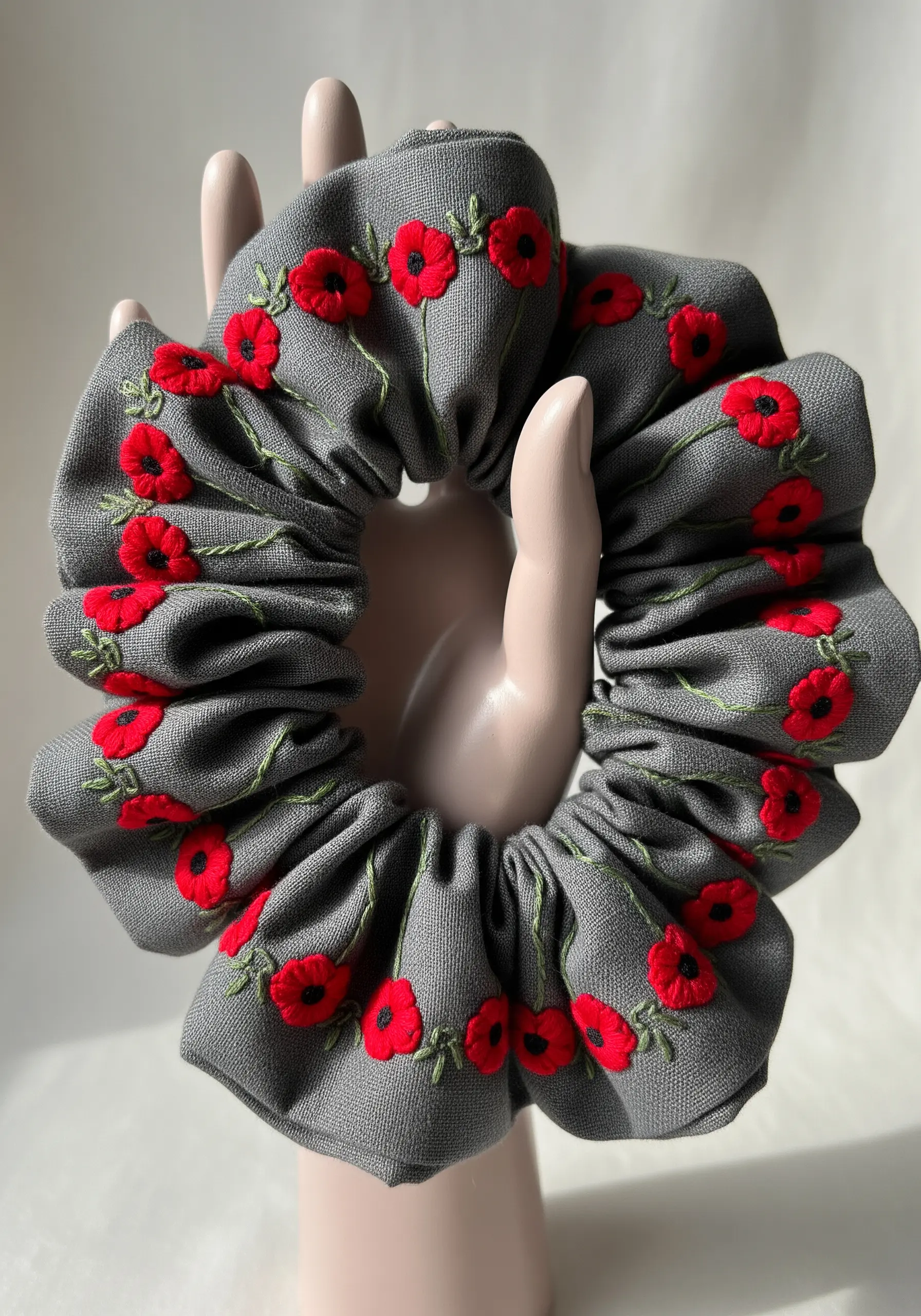 Red poppy embroidery on grey linen scrunchie