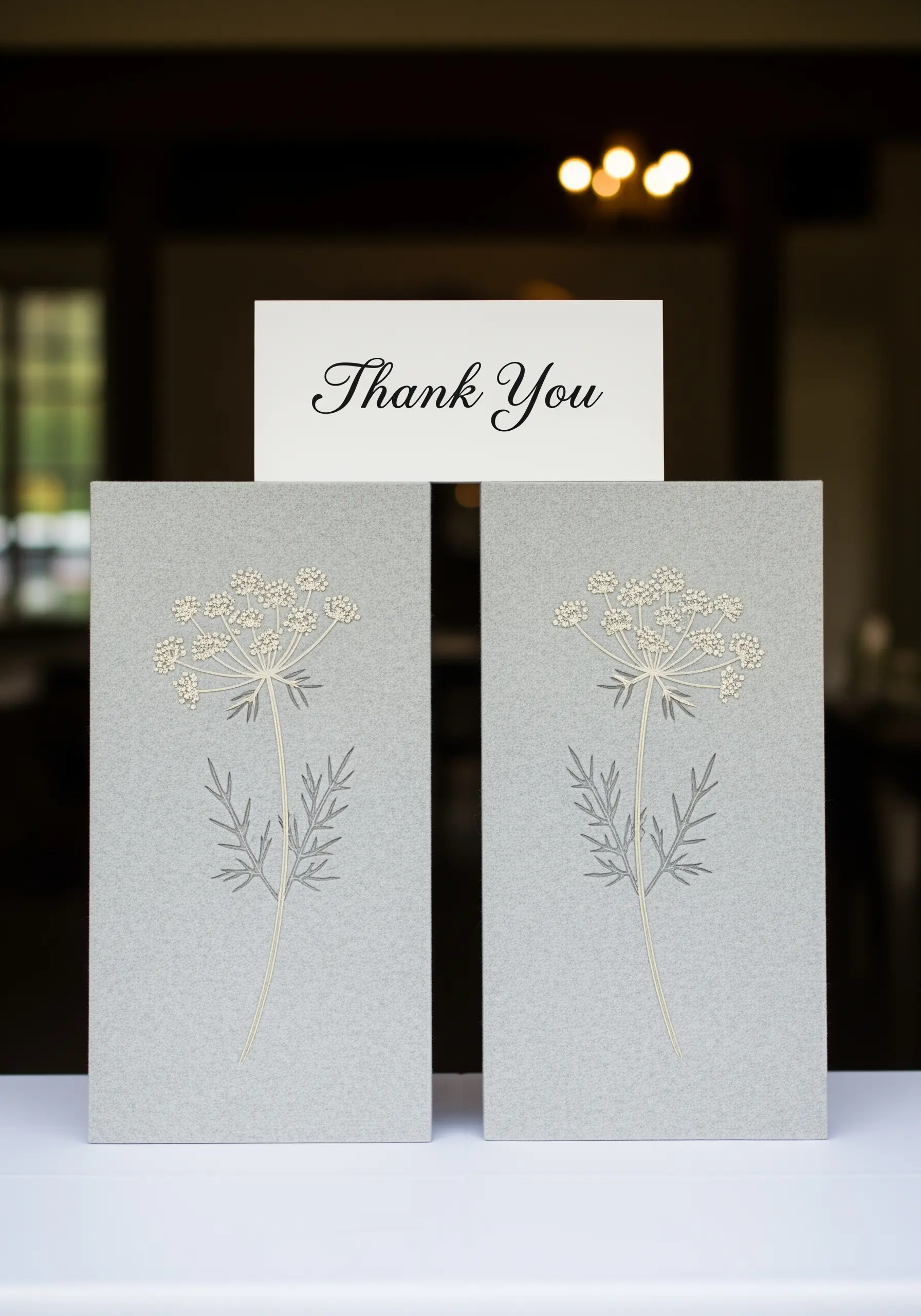 Thank you cards made from grey paper, embroidered with delicate Queen Anne's Lace flowers.