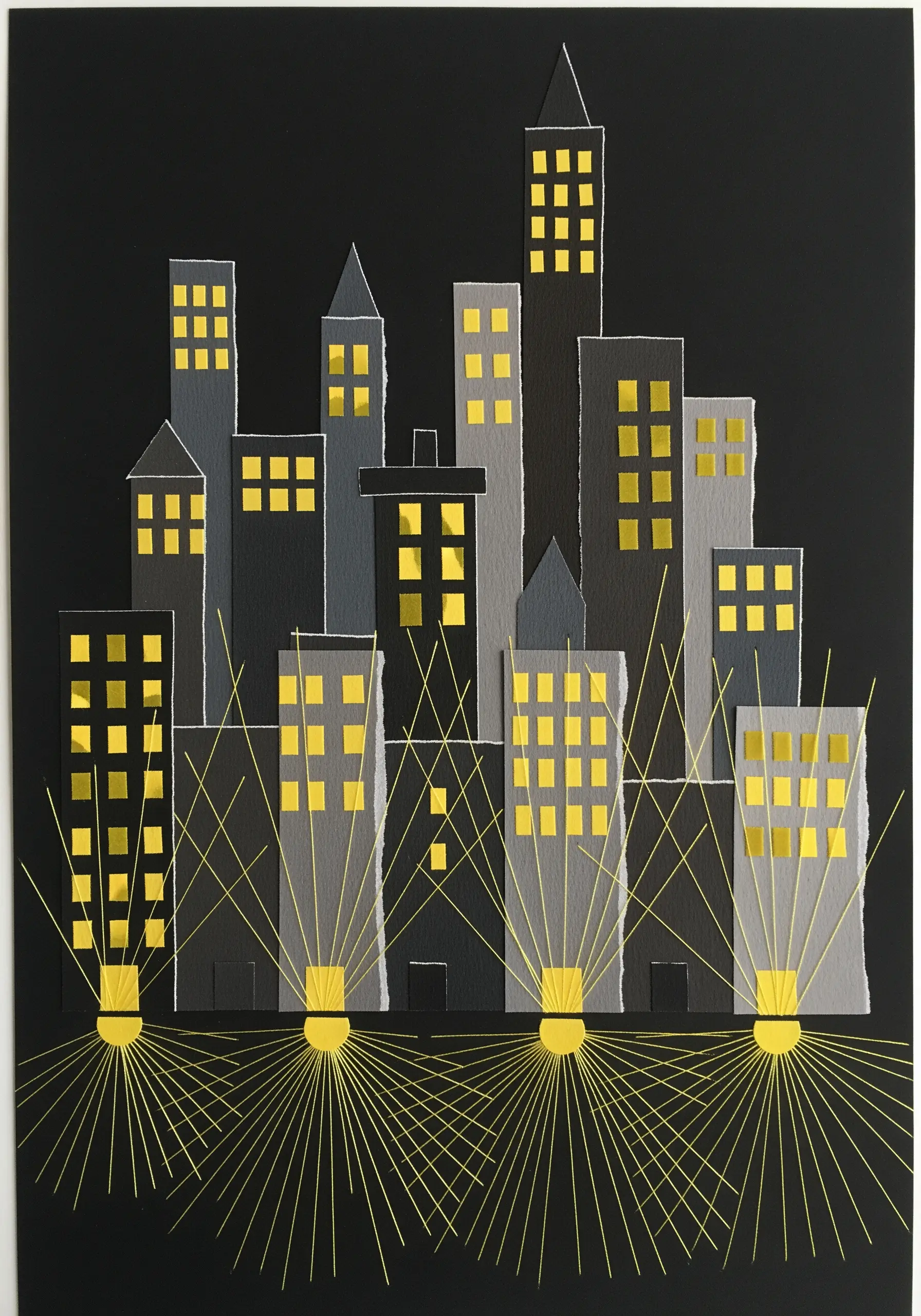 Paper collage cityscape at night with yellow thread radiating from streetlights to simulate light.