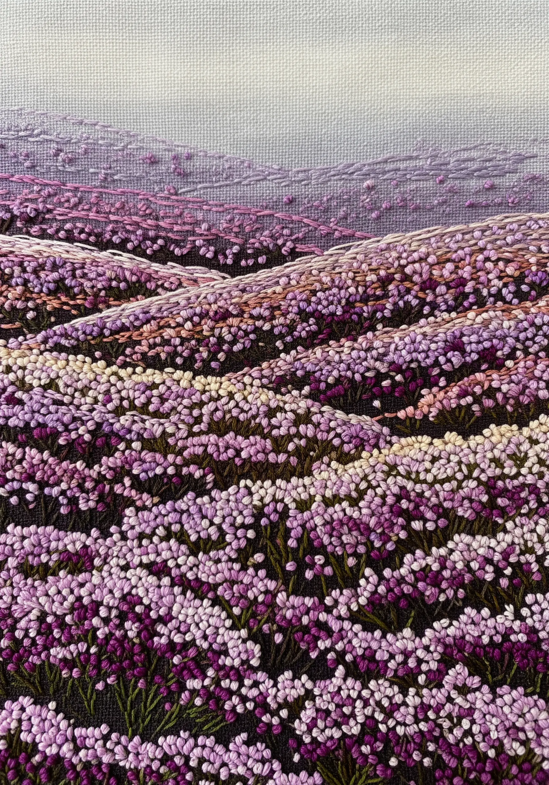 An embroidered landscape of purple heather fields using dense French knots for texture.