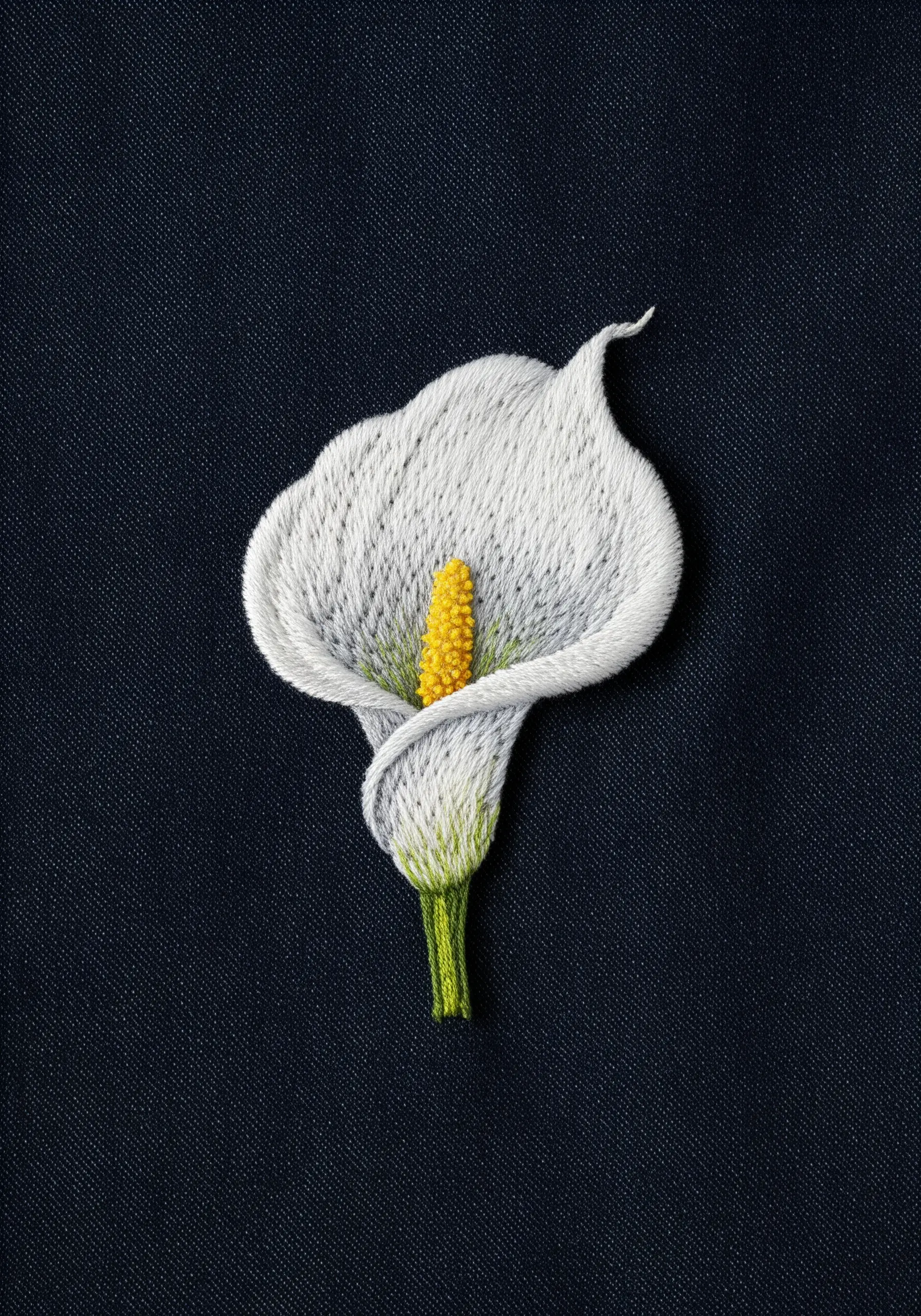 A realistic, thread-painted white calla lily with a yellow center on a dark fabric background.