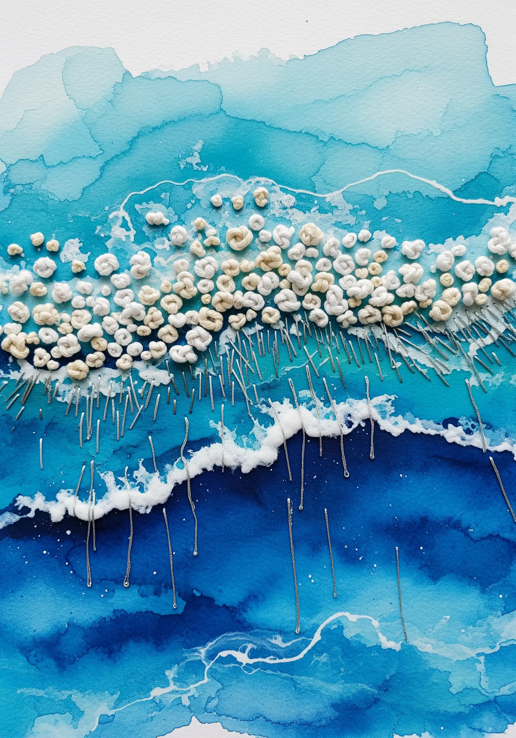 Abstract watercolor ocean with dense white French knots and long silver stitches.