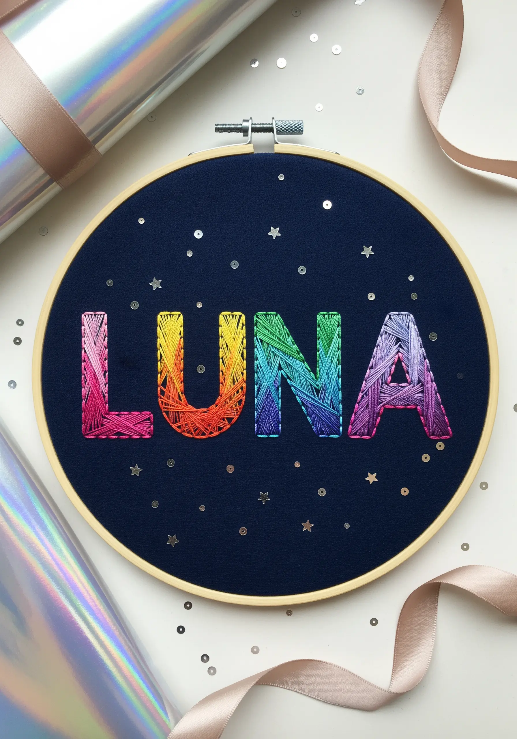 Embroidered name with a smooth rainbow gradient fill and scattered sequin stars.