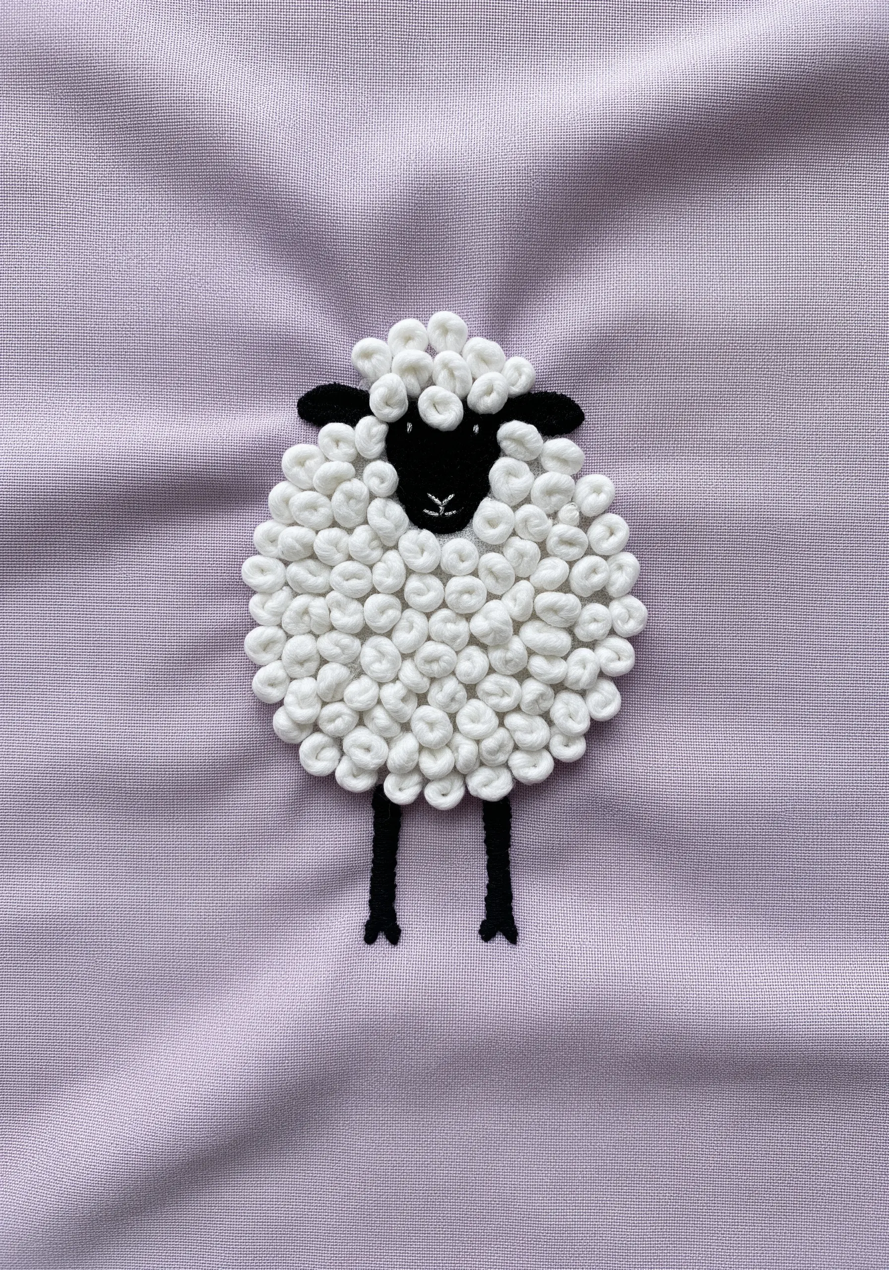 Sheep embroidery entirely filled with white French knots for wool texture