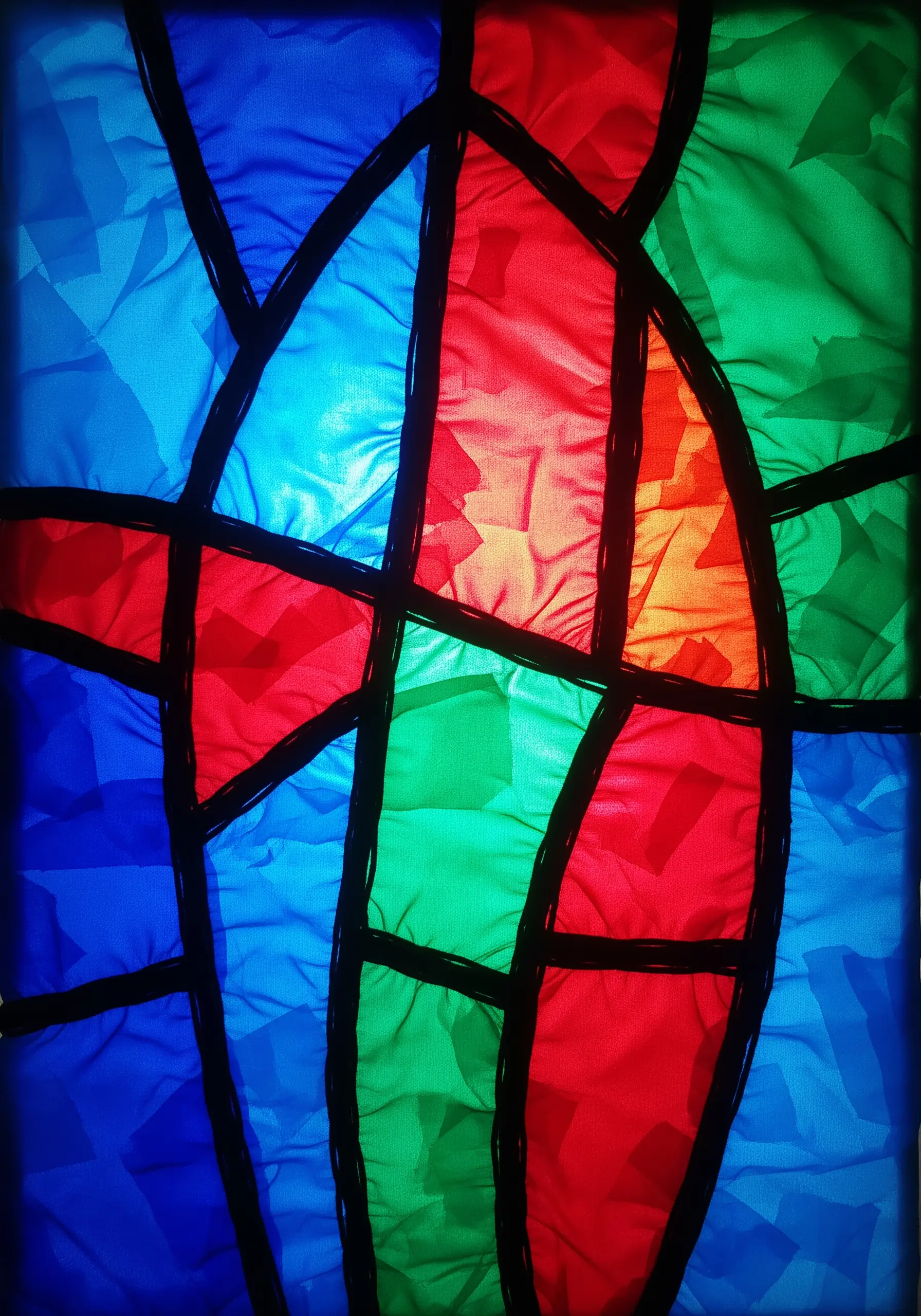 A vibrant collage of crumpled, colorful translucent paper outlined with thick black yarn.