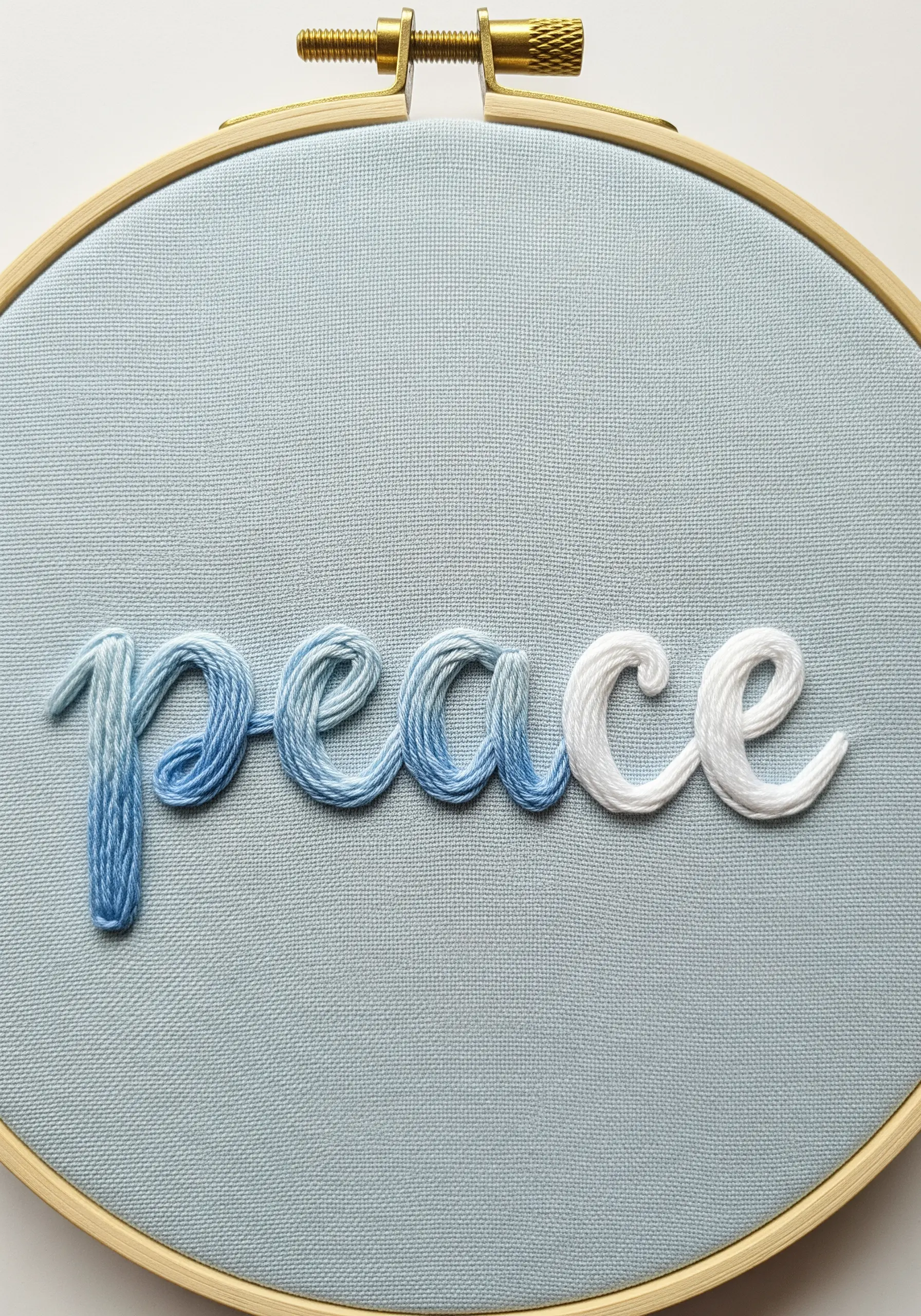 The word 'peace' in a blue-to-white ombré satin stitch.