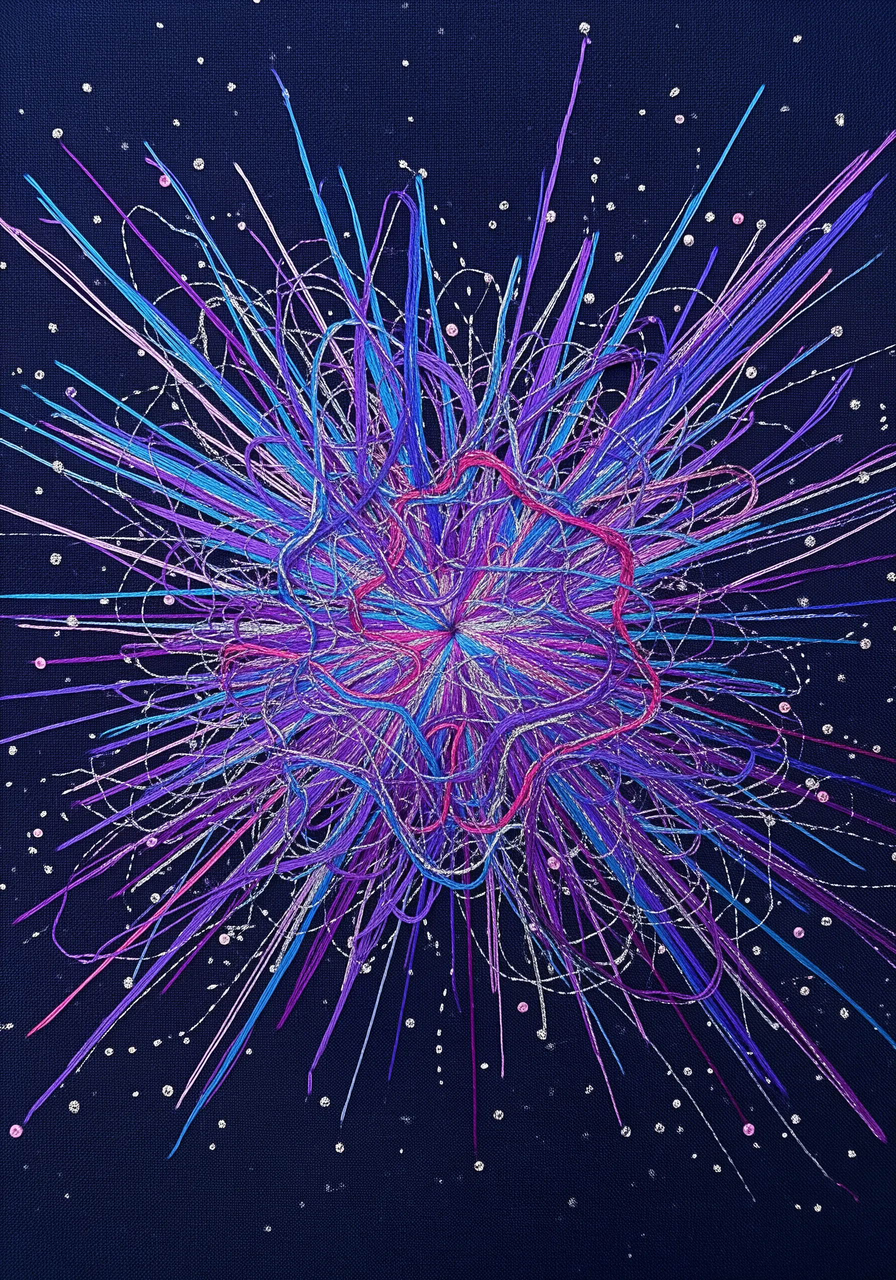 An abstract explosion of purple, blue, and pink threads on a dark navy fabric with silver accents