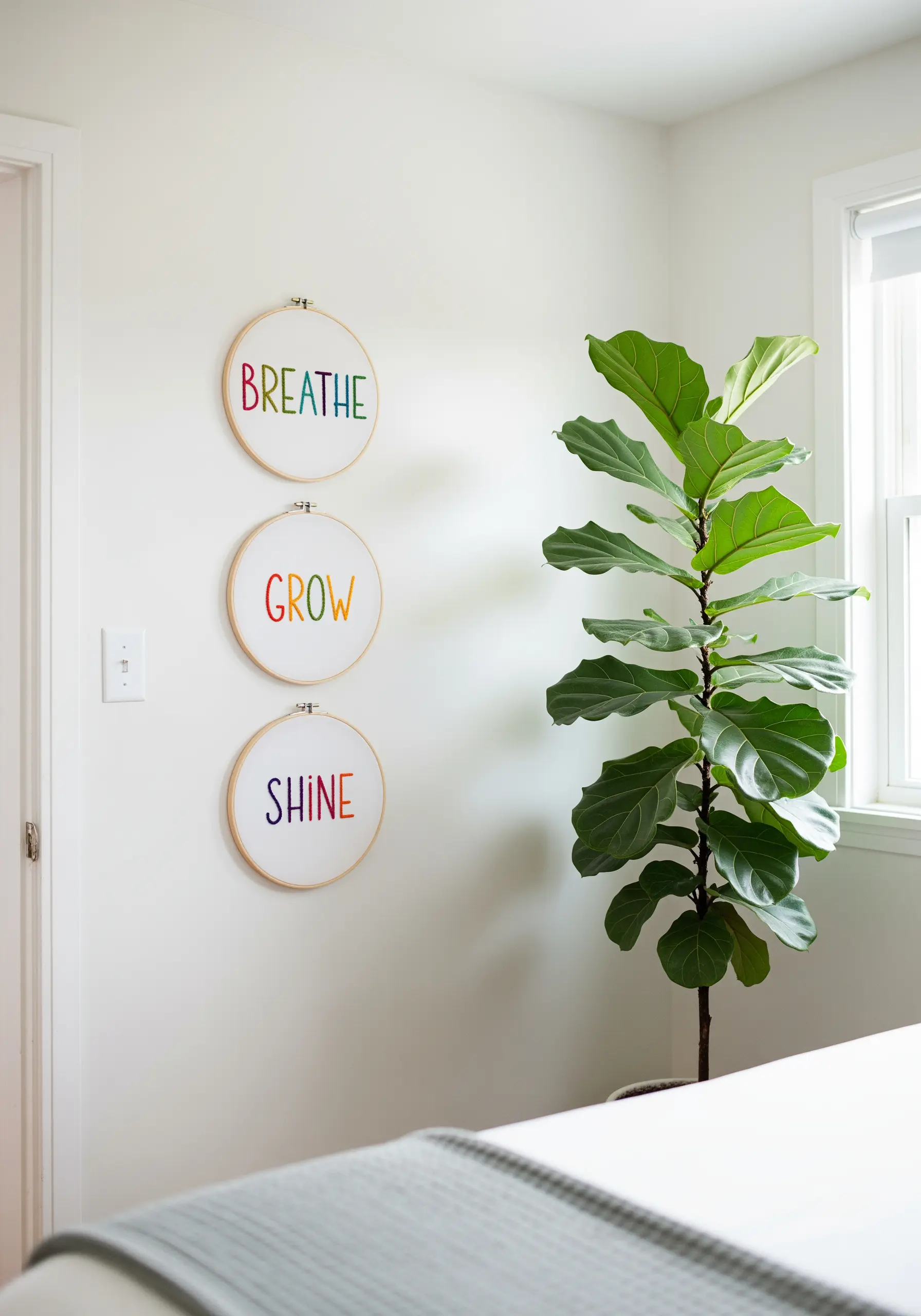 Three hoops with the words BREATHE, GROW, SHINE stitched in a soft rainbow gradient.