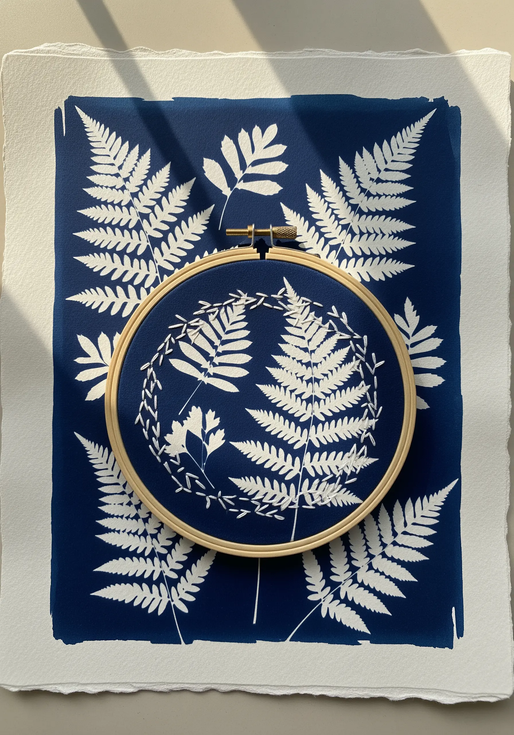 Cyanotype fern print with white embroidery highlights