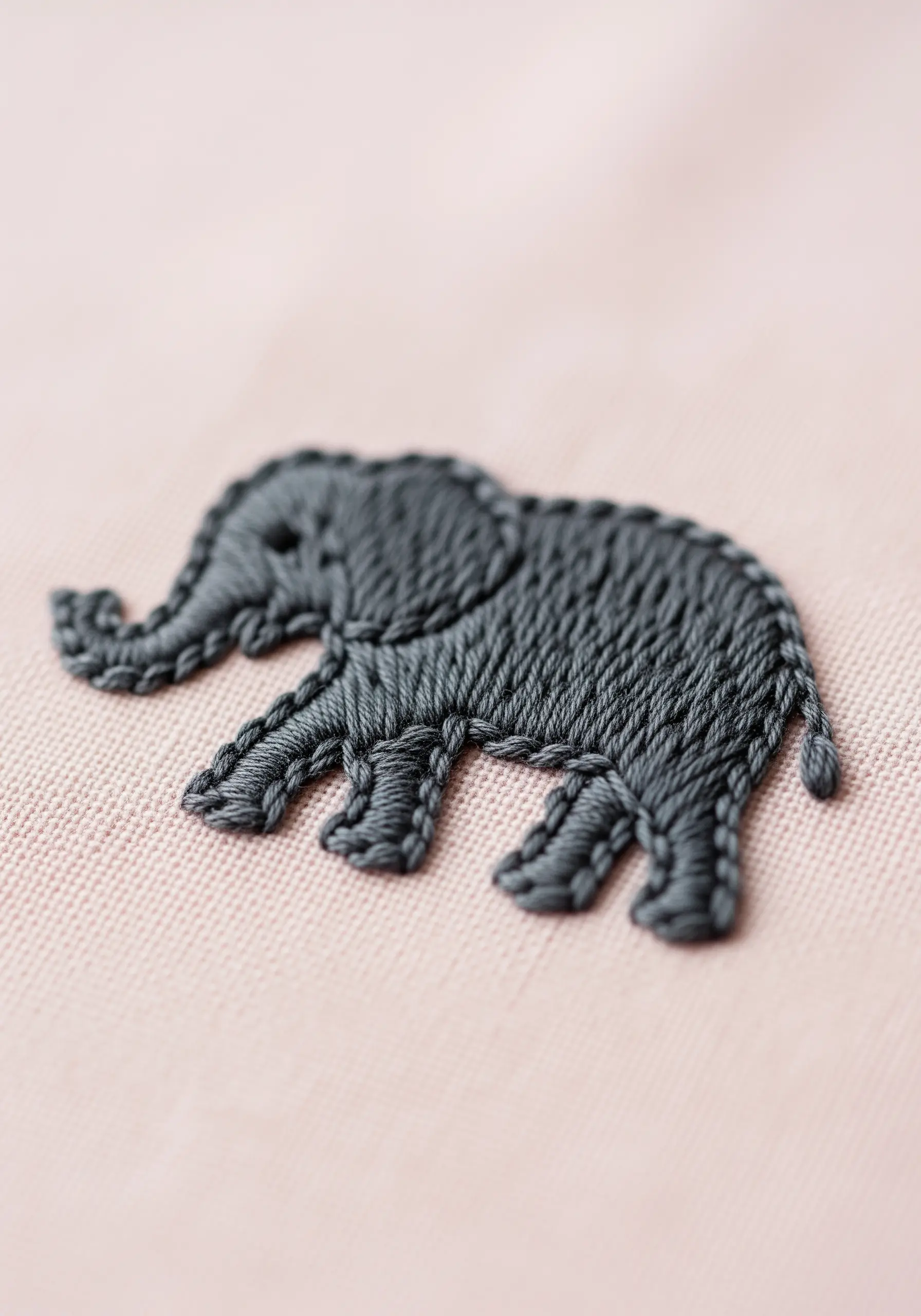 Small elephant embroidery with textured dark grey thread filling