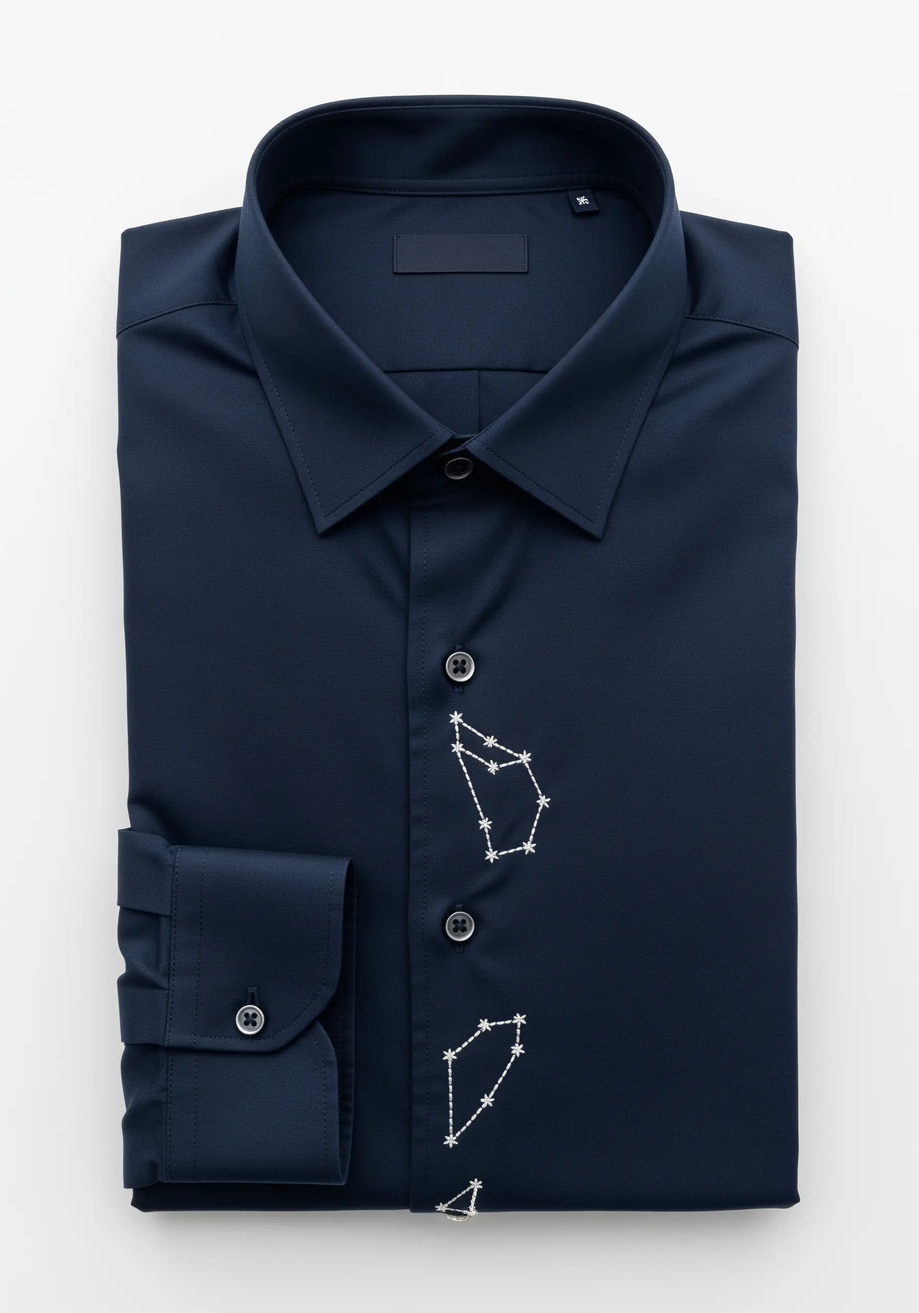 White embroidered constellations scattered along the placket of a navy shirt.
